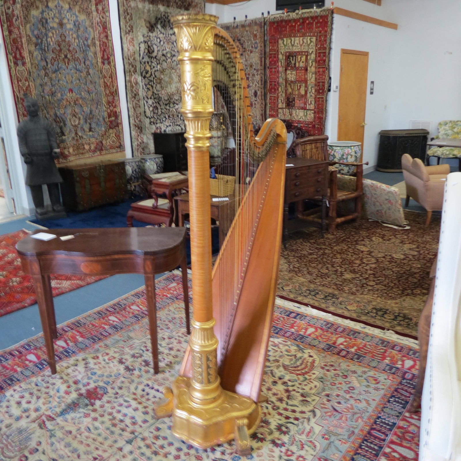 19th Century Harp by Charles T. Laughton,: Student Symphony model, with some tiger maple, gold trim on column designs with carved leaves, 70" tall, lacking pedals.