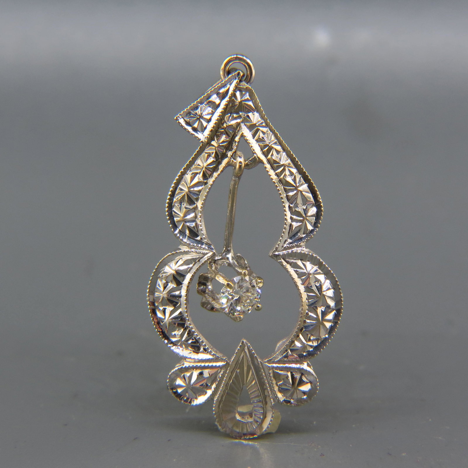 Diamond 14K White Gold Pendant,: lavaliere style with .25 carat round brilliant diamond dangling in center, with appraisal of $1,050.00, overall 1 3/4" long.
