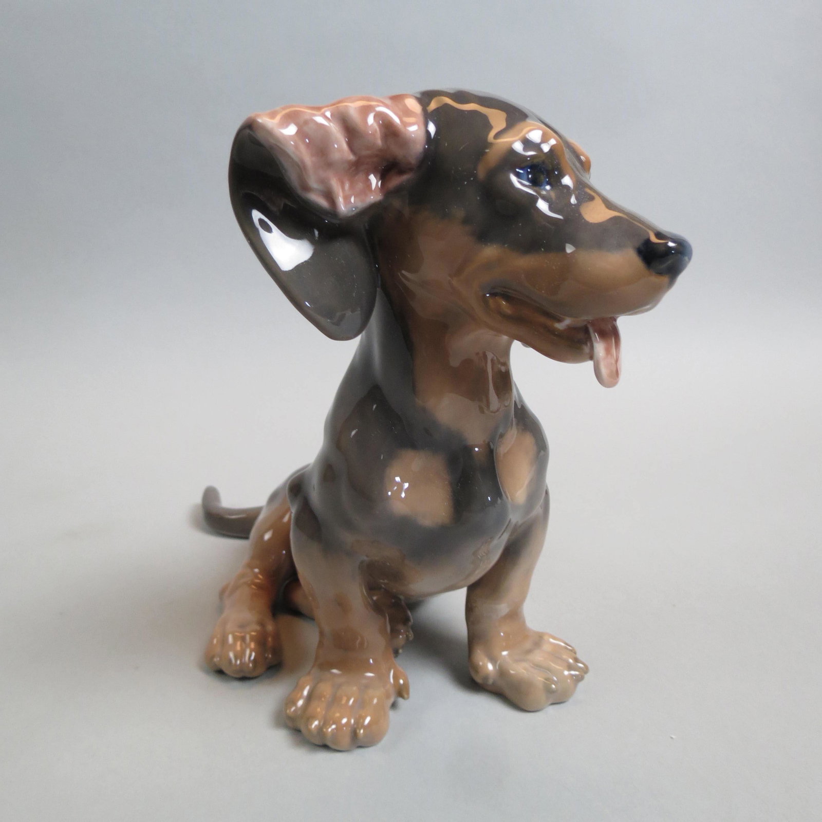 Royal Copenhagen Porcelain Figurine of a Dachshund: seated, 7 1/2" tall, #856, artist F.P., excellent.