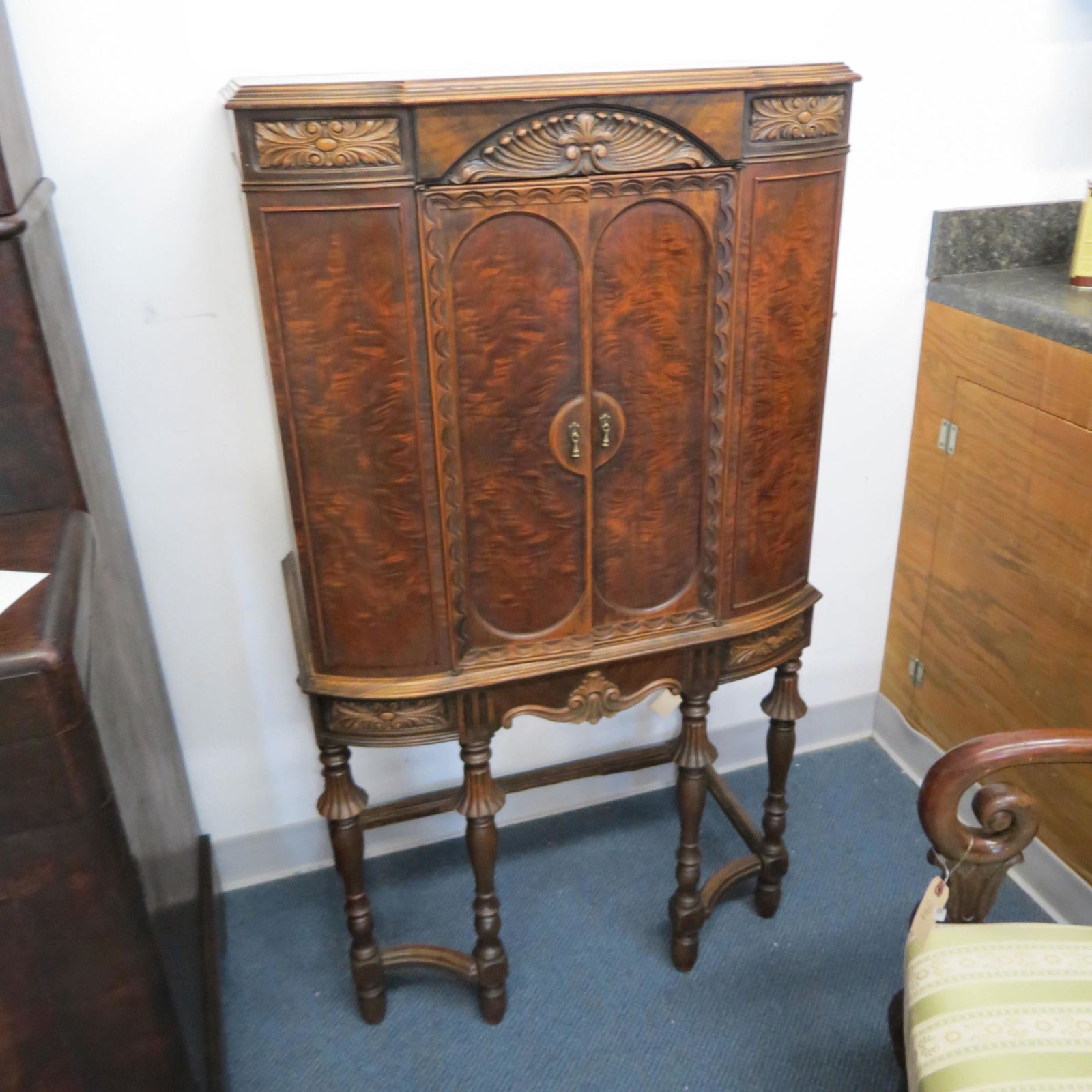 Art Deco Cabinet,: burl trim, carved designs, 50" tall, 27" wide, 17" deep.