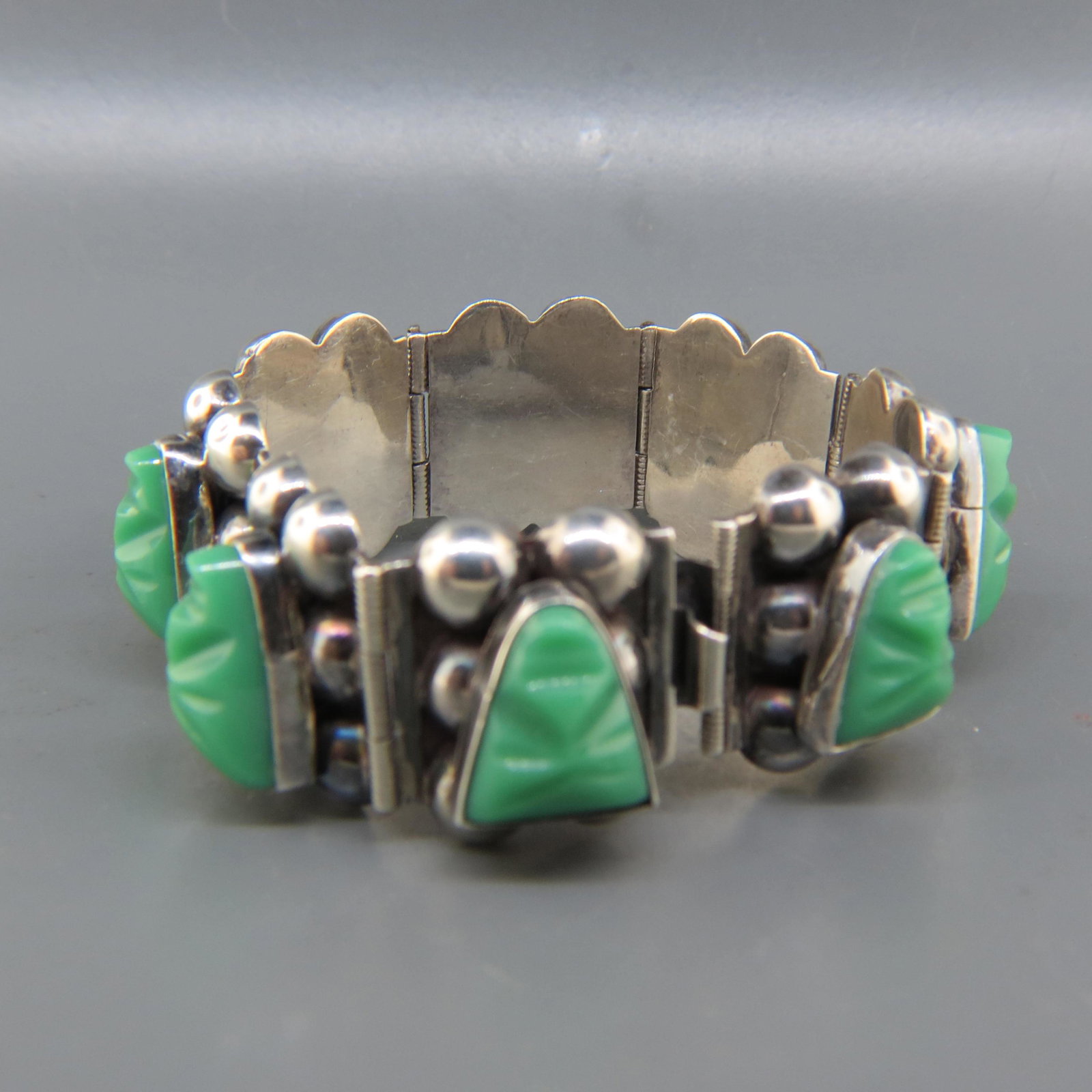 Mexican Sterling & Carved Green Agate Bracelet,: vintage, 8 Aztec faces, 7/8" wide, 7" long, excellent, 54 grams.