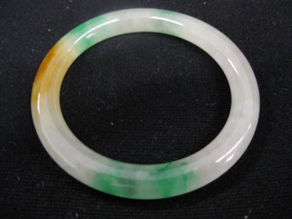 Jade Bangle Bracelet, mottled with green & brown h: mottled with green & brown highlights, 2 1/8" opening.