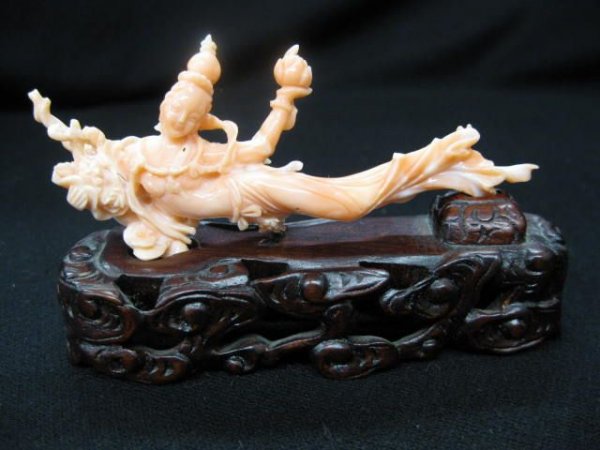 Chinese Carved Coral Figurine of Quan Lin, 4 1/8": 4 1/8" long on carved wooden stand.