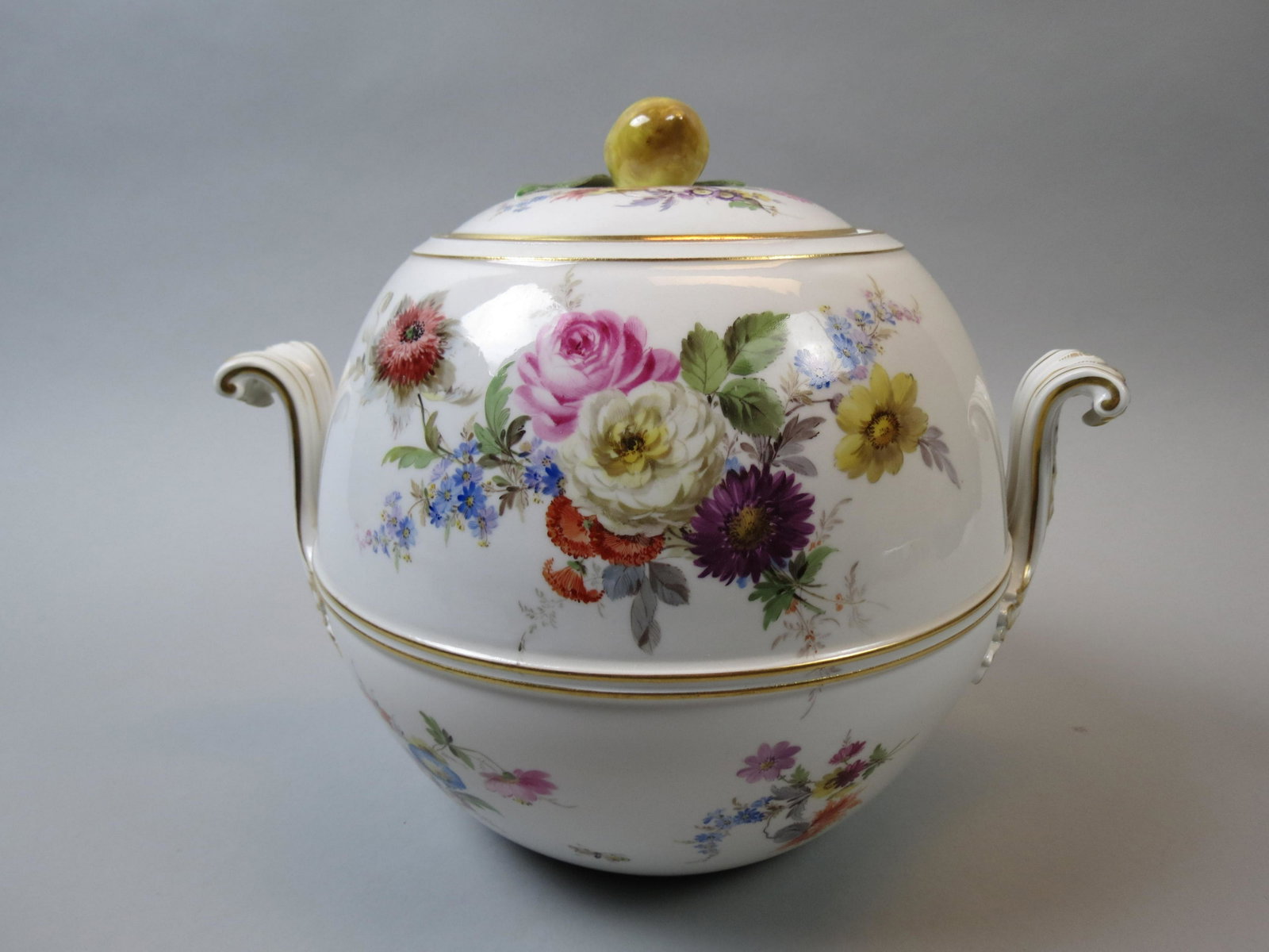 Meissen Porcelain Tureen: Handpainted butterfly flowers, gold trim, figural lemon finial on cover, 10" tall, 9" diameter, crossed swords mark.