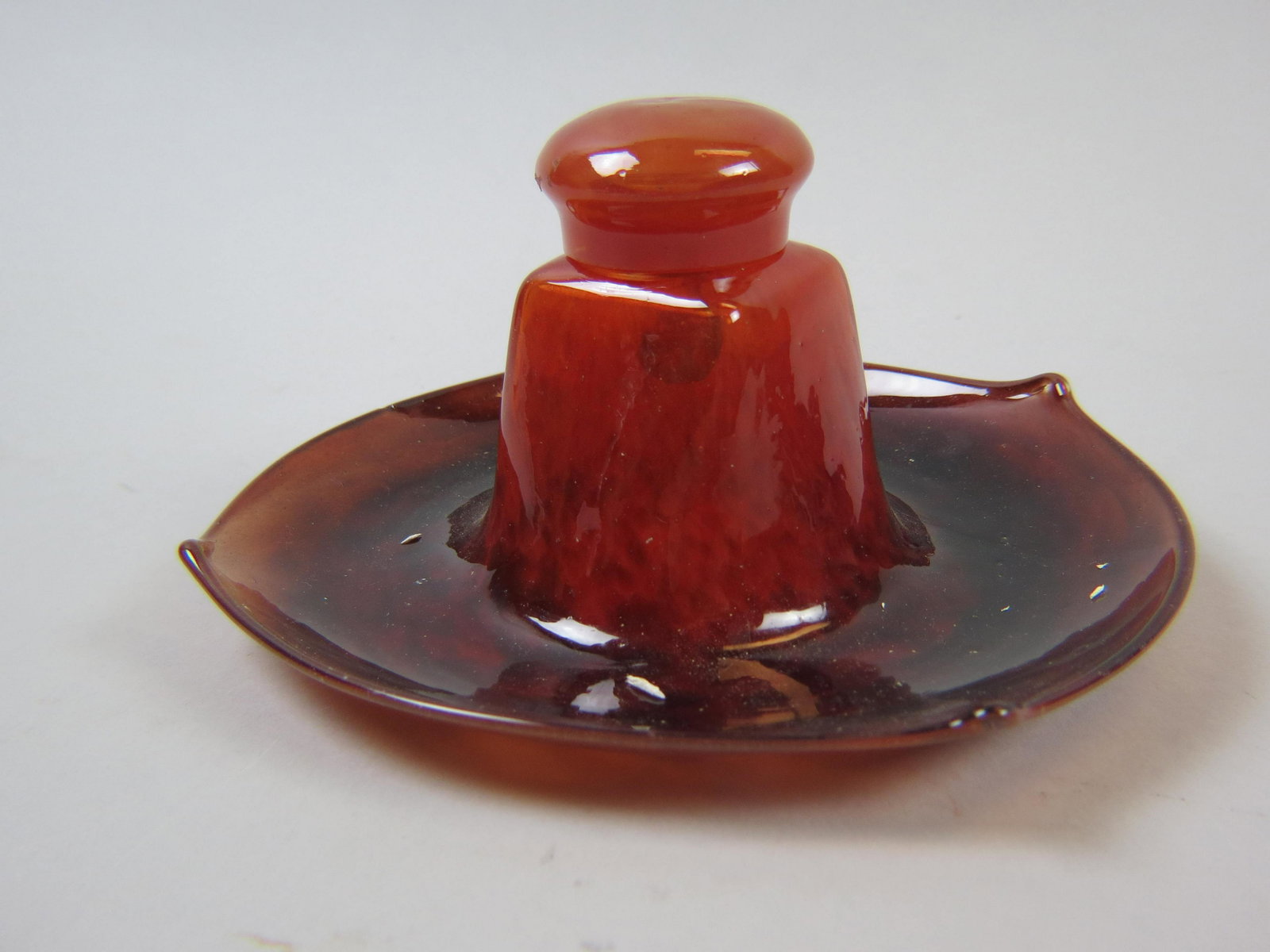 French Art Glass Inkwell from Ovingtons: Art Deco style, mottled burgundy to orange, attributed to Daum, 7 1/2" diameter, 3 3/4" tall, excellent.