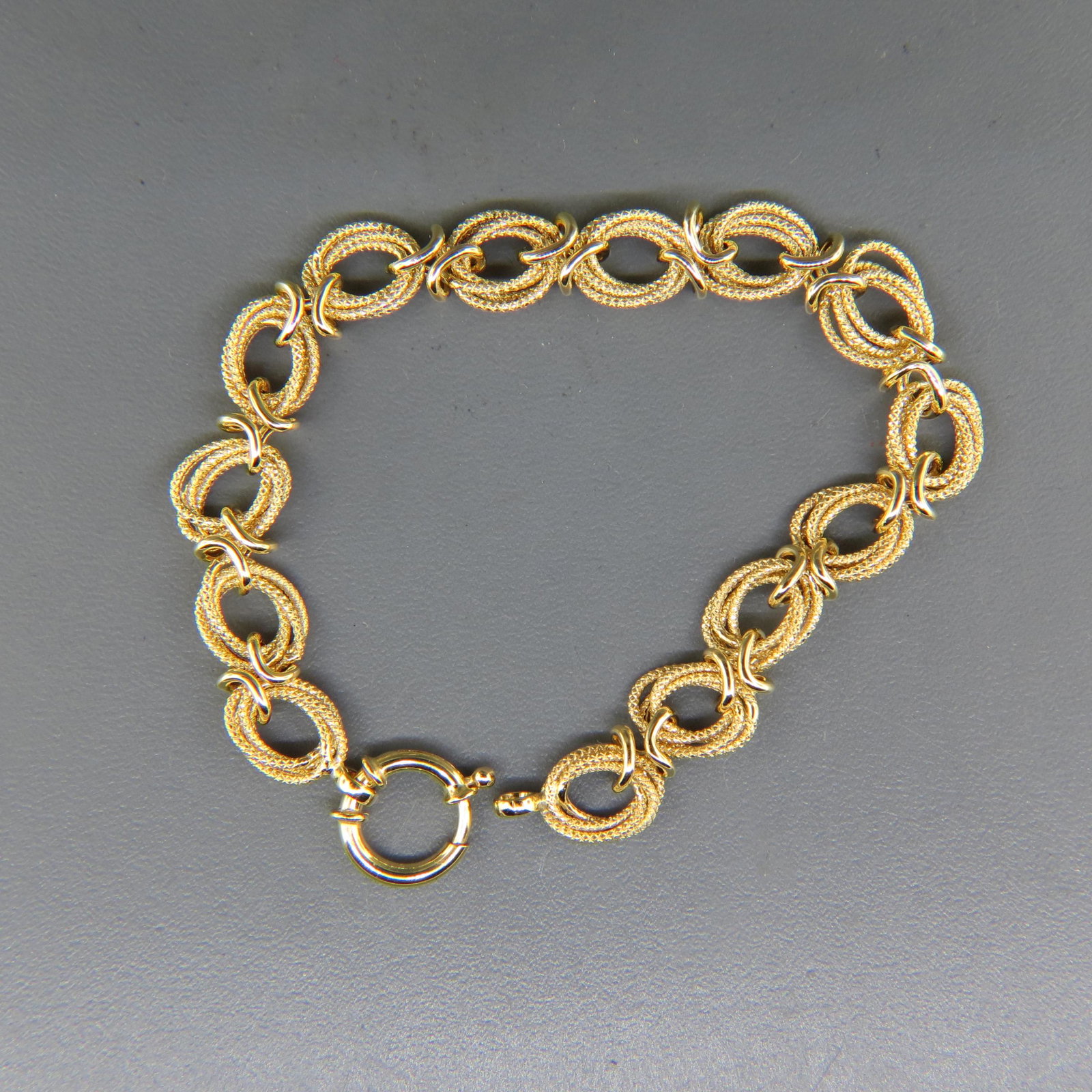 18K Gold Bracelet: Triple oval rope links, 1/3" wide, 7" long, 6.8 Grams.