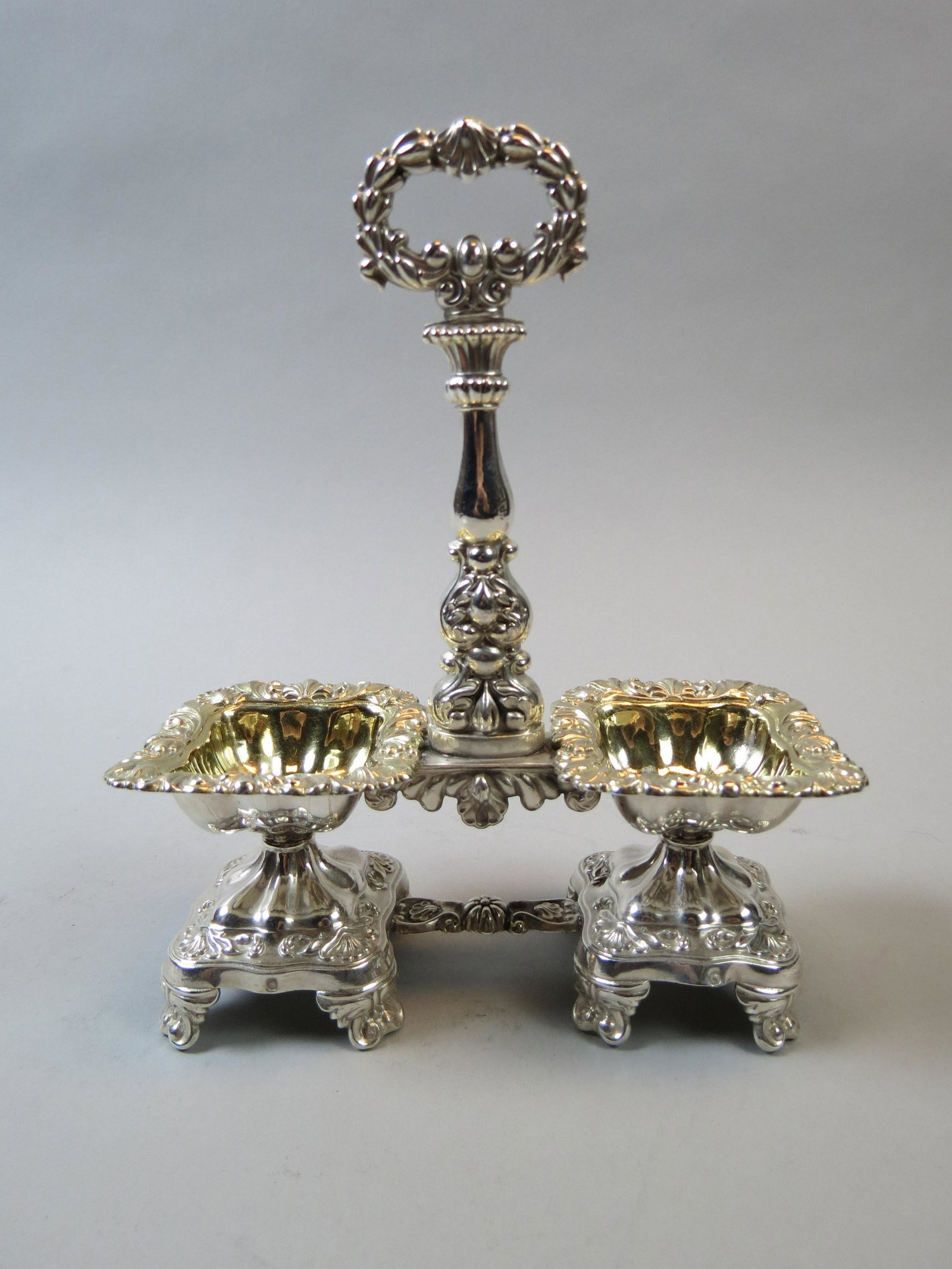 European Silver Master Salts with Center Handle: Gold interior, footed, hallmarked, 19th century, 8" tall, 7" across, 287 grams.
