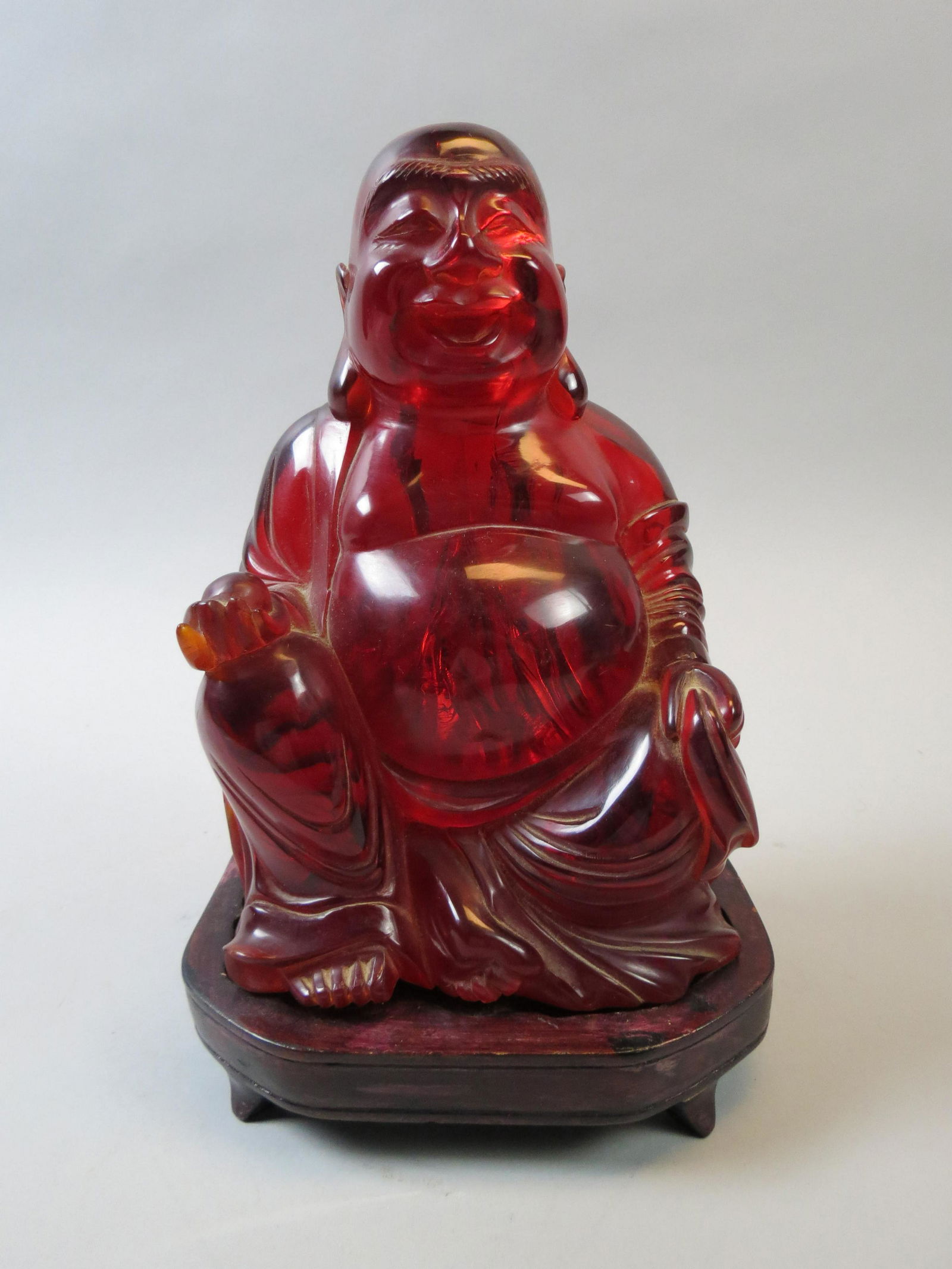 Chinese Cherry Amber (?) Figurine of a Seated Buddha, (1 of 8)