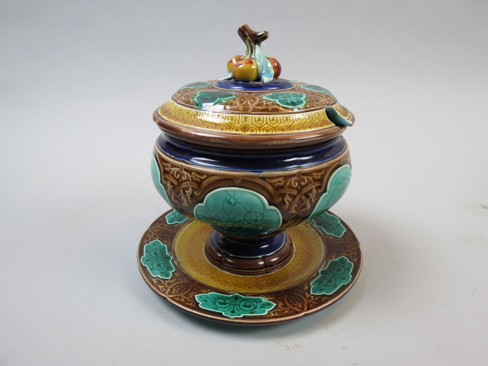 Sarreguemines French Majolica Pottery Tureen: Sarreguemines French Majolica Pottery Tureen, sauce size, fruit floral, attached under plate, 7 1/2" tall, 7" diameter (under plate), 19th century, excellent.