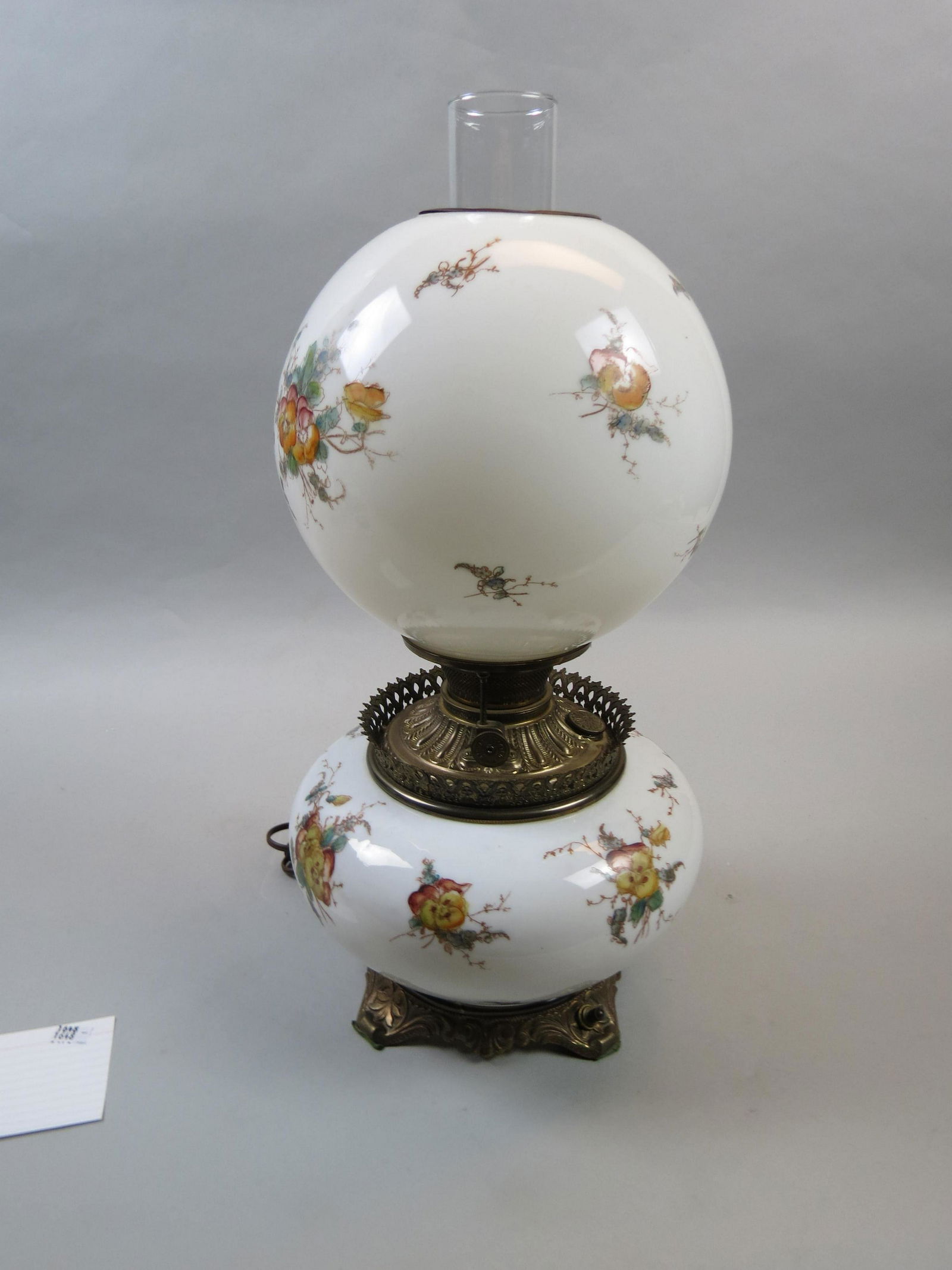 Victorian Gone-with-the-Wind Lamp: Victorian Gone-with-the-Wind Lamp, floral sprays on milk glass, bronzed base, all original, with reciept from W.B. Mullard Antiques in 1949 ($45.00).