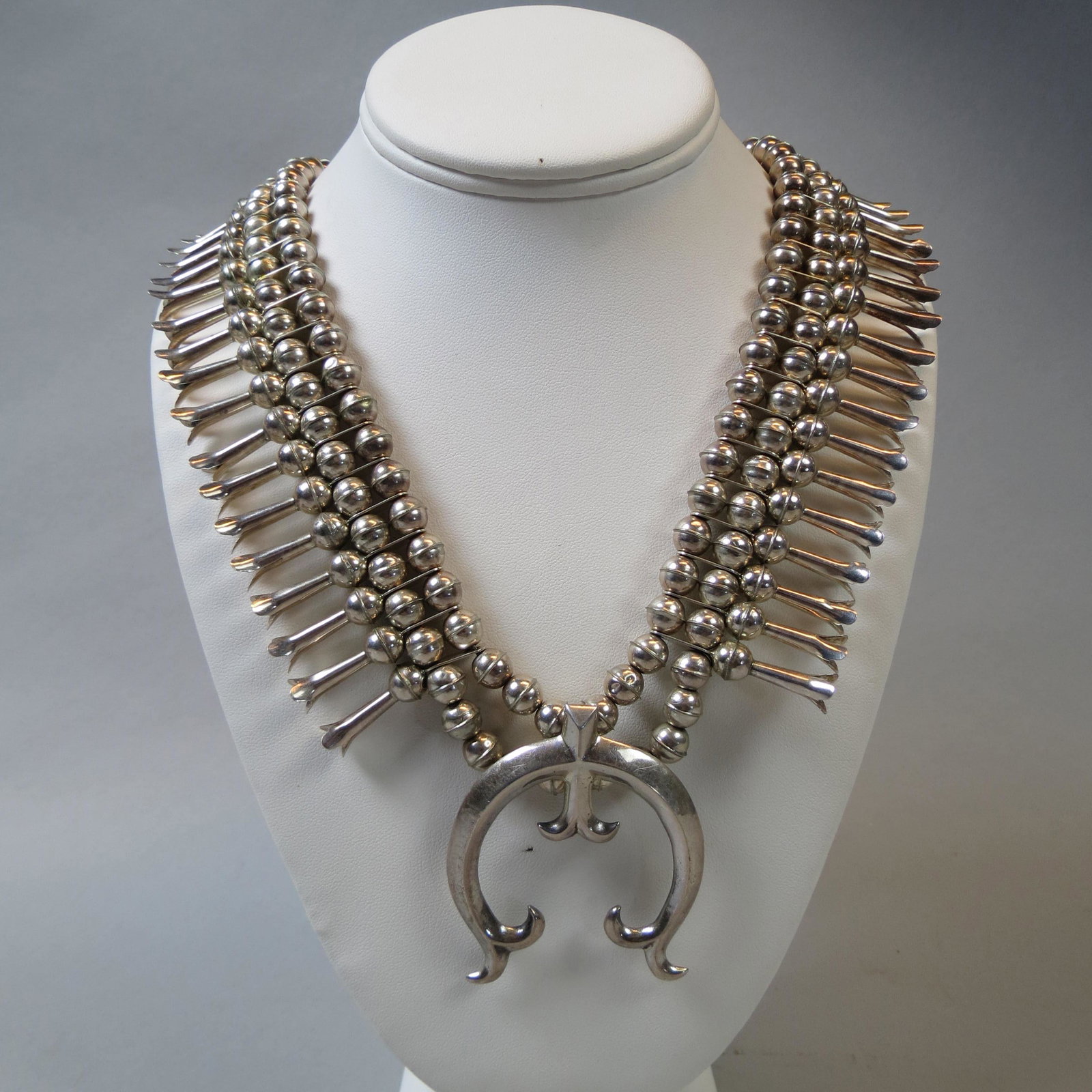 Navajo Sterling Squash Blossom Necklace: Navajo Sterling Squash Blossom Necklace, classic blossom and Naja shapes, 30" long, 115 grams, unsigned.