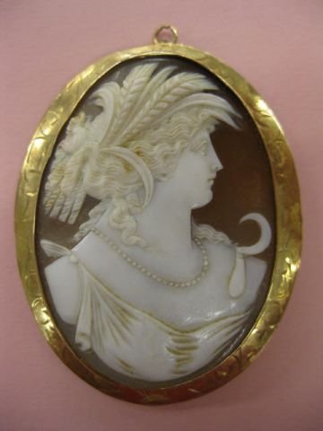 Cameo Pin or Pendant, carved cowry shell portrait : carved cowry shell portrait of harvest peasant girl in 10k engraved yellow gold setting, 1 7/8" x 2 3/8".