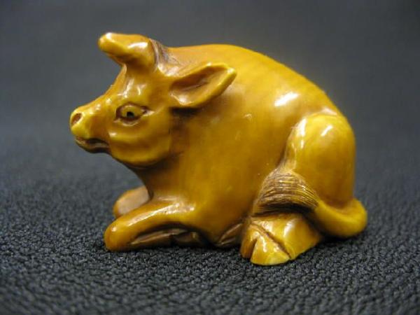 Carved Ivory Netsuke of an Ox,: signed, 1" x 1 1/2", excellent.