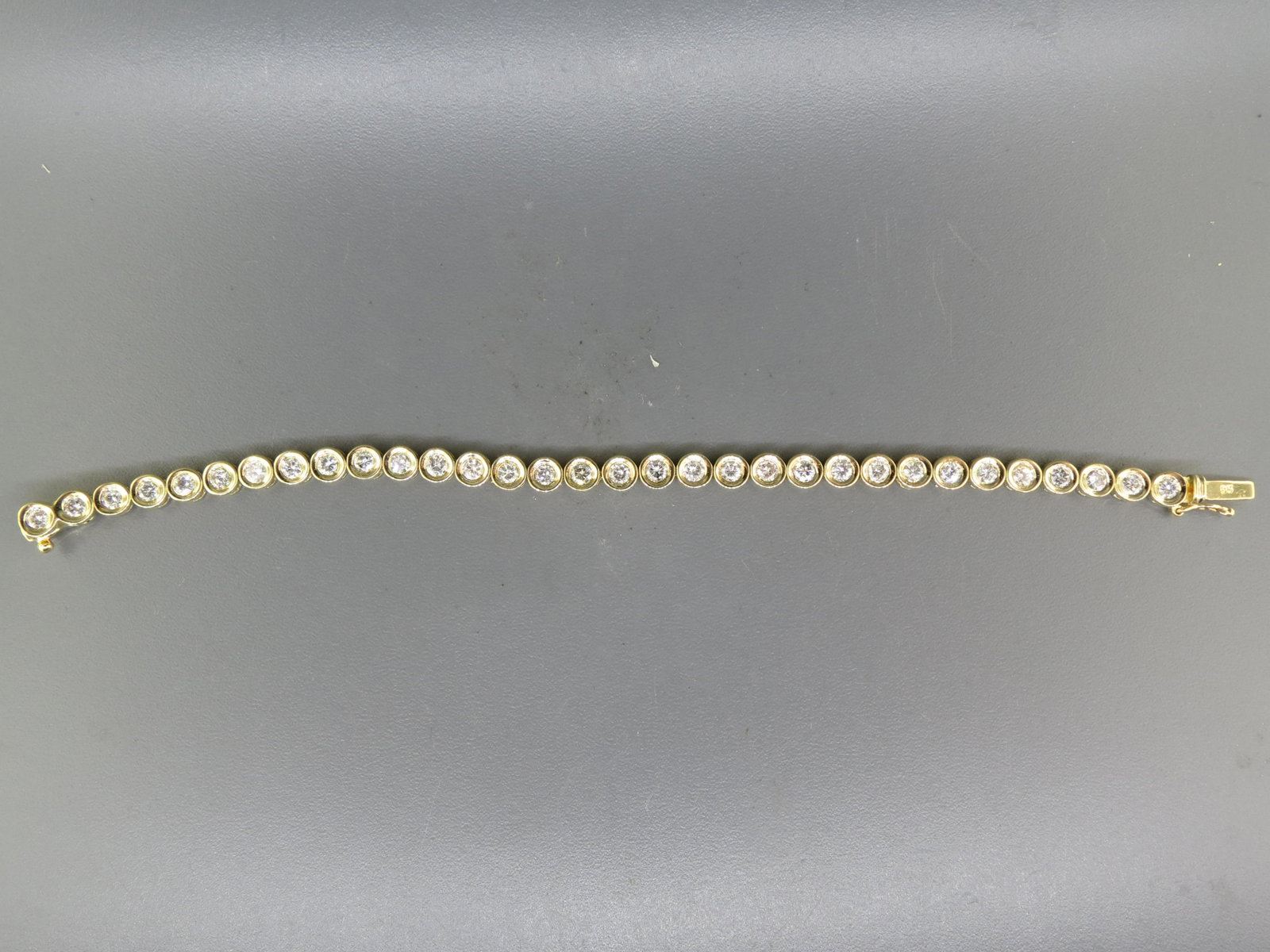 Diamond Bracelet, 14K Gold with 4 Carats,: 32 round diamonds totaling 4 carats, nicely bevel set in yellow gold, with appraisal of $6,300.00, 7" long.