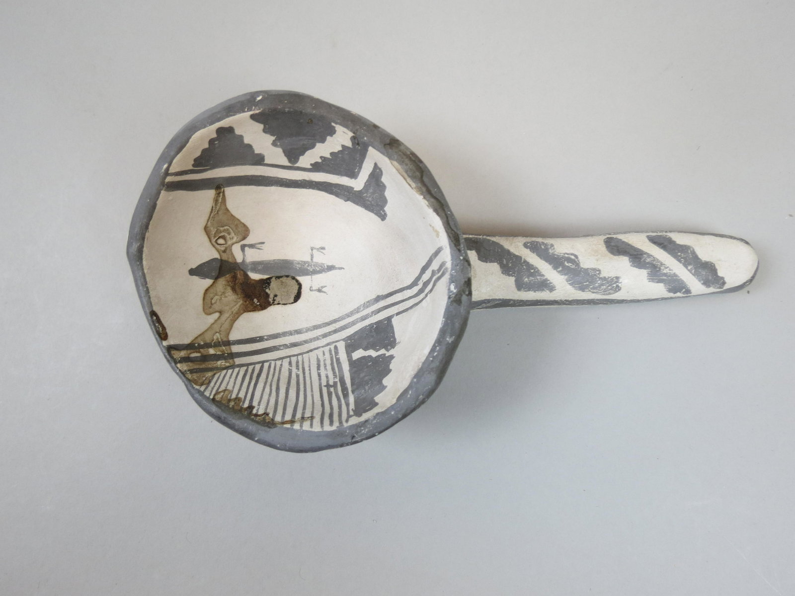 Anasari Pre-Historic Pottery Ladle.: geometric and gilo monster design, 7 1/2" long.