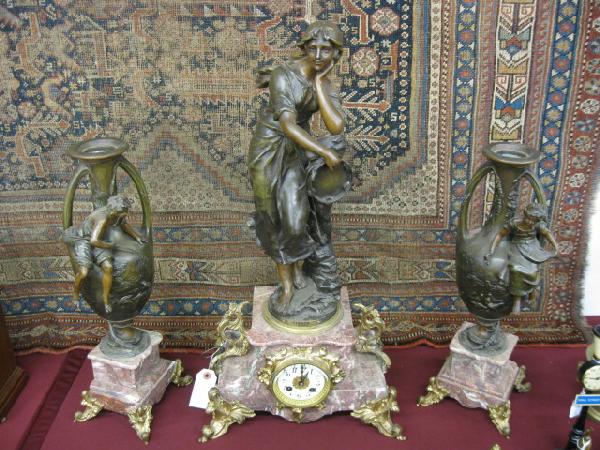 French Victorian Figural Bronze Mantle Clock Set: 26" tall clock with "Mignon" holding tamboreen, side garnitures with Art Nouveau style, peasant boy & girl on vases, rouge marble, working.