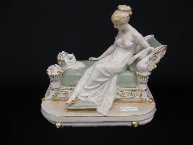 German Porcelain Figurine of Lady on Chaise, dog: dog by her side, swan & cornucopia trim, 9", late 19th century.