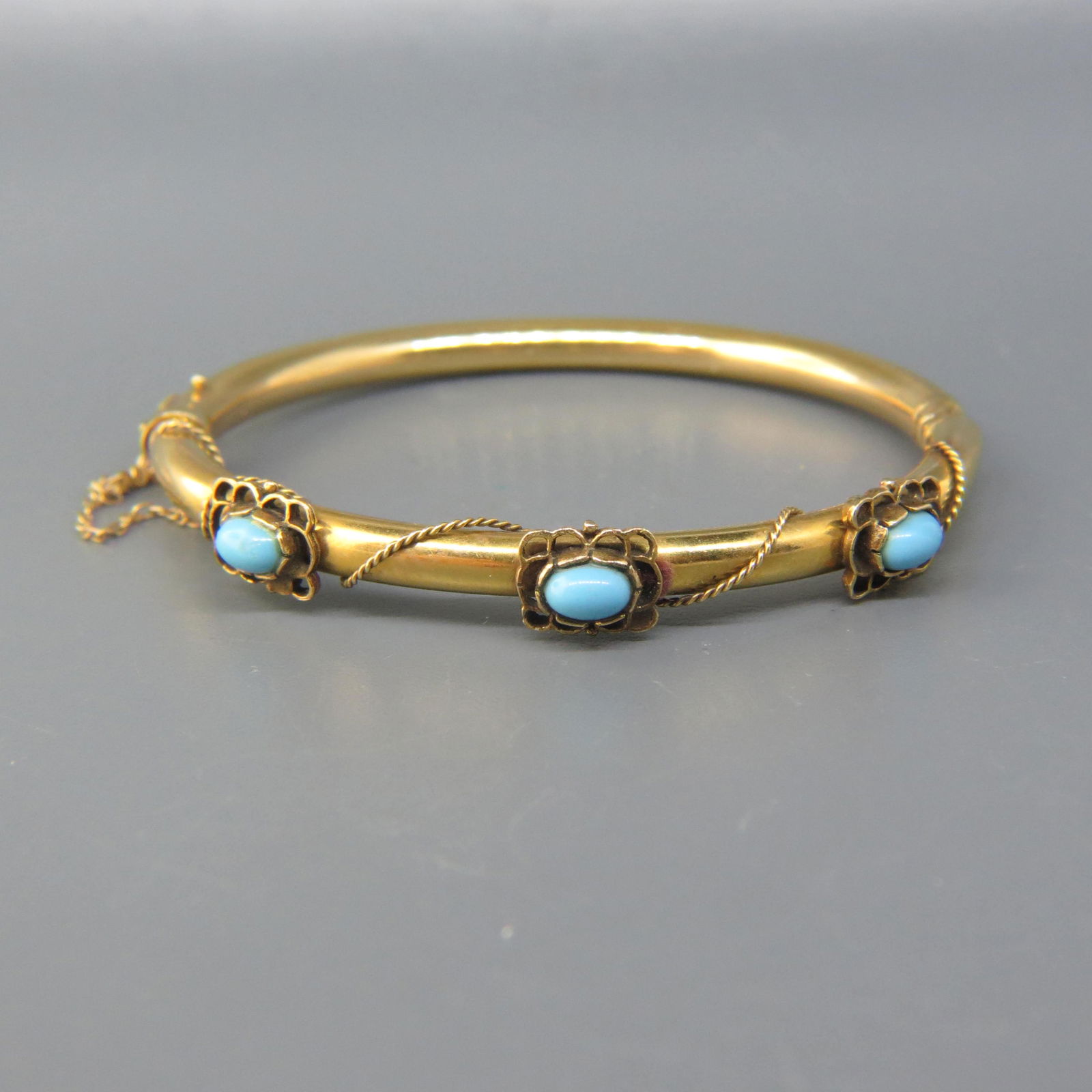 Antique 14K Gold & Turquoise Bracelet: Tubular style bangle with a trio of Persian blue oval cabochons, 14K yellow gold, 14 grams, 6 1/2" wrist size.