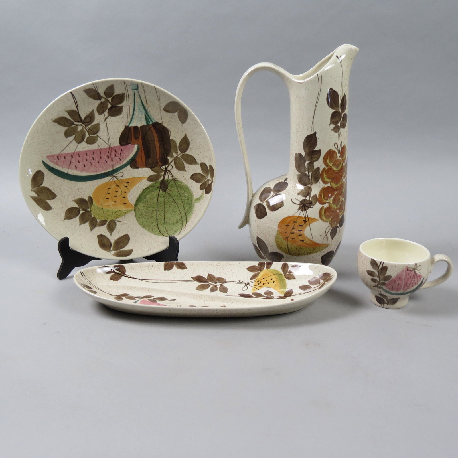 38 pcs. Redwing Tampico" Pottery Dinnerware,": Decorated with Tampico wine bottle, watermelon and cantaloupe, service for 8 plus pitcher, sugar, creamer, butter and more, excellent.