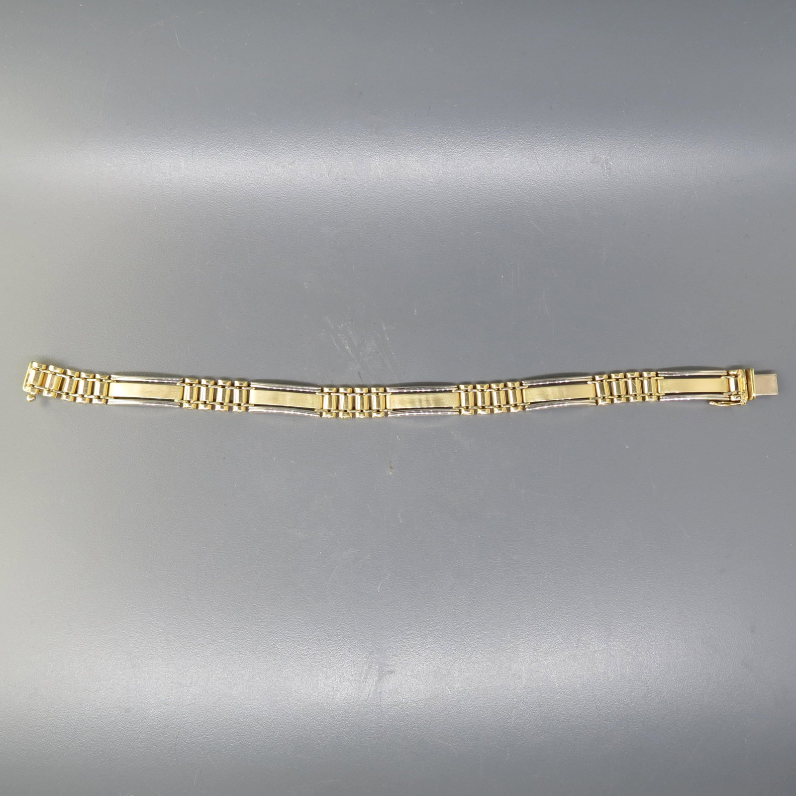 14K Gold Bracelet: Yellow and white gold with unusual links, signed B & M, 7 5/8 long, 19.8 grams.