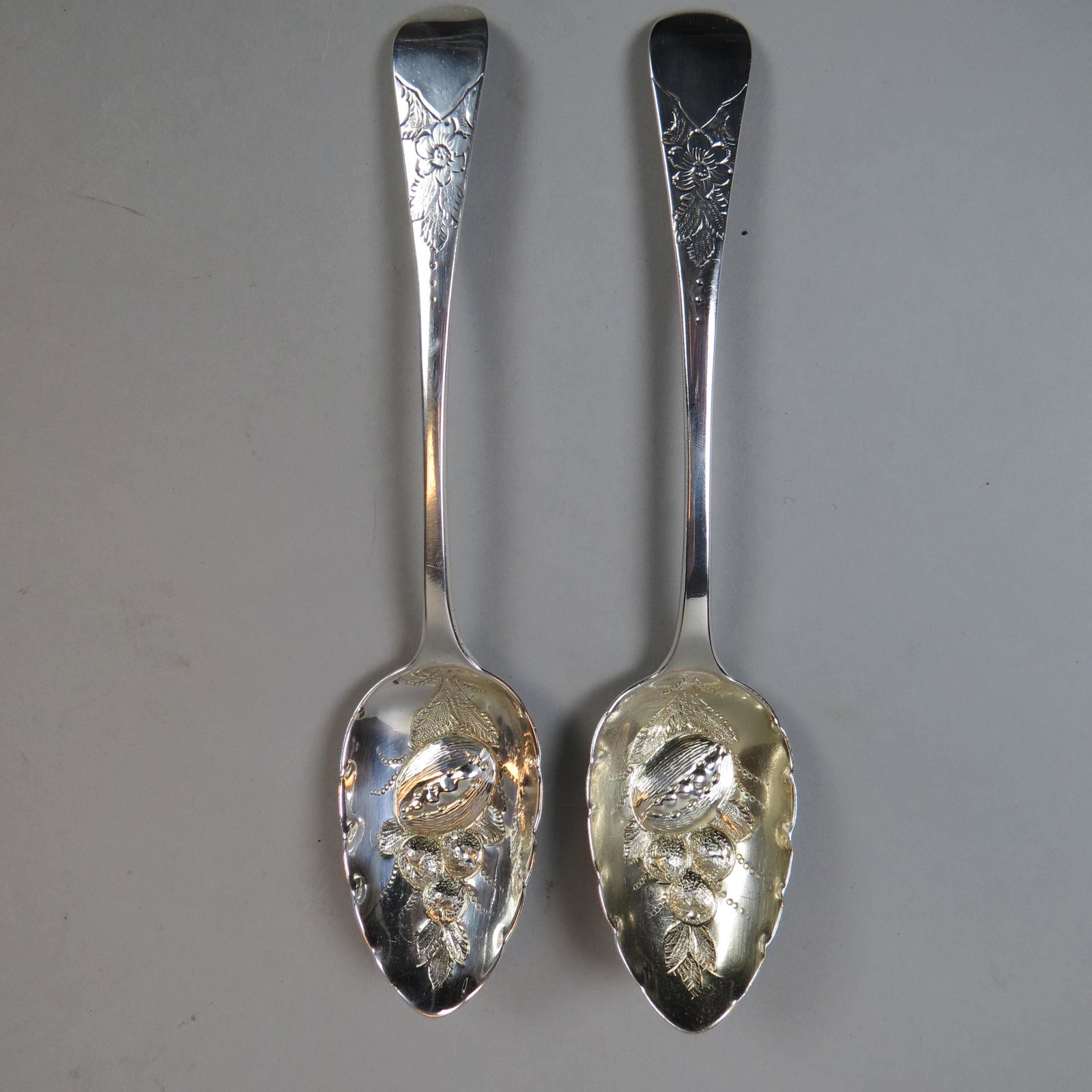 Pair of 1823 English Sterling Berry Spoons: Elaborate bowls with raised berries, hallmarks of London, 9, no monogram, excellent, 139 grams total.