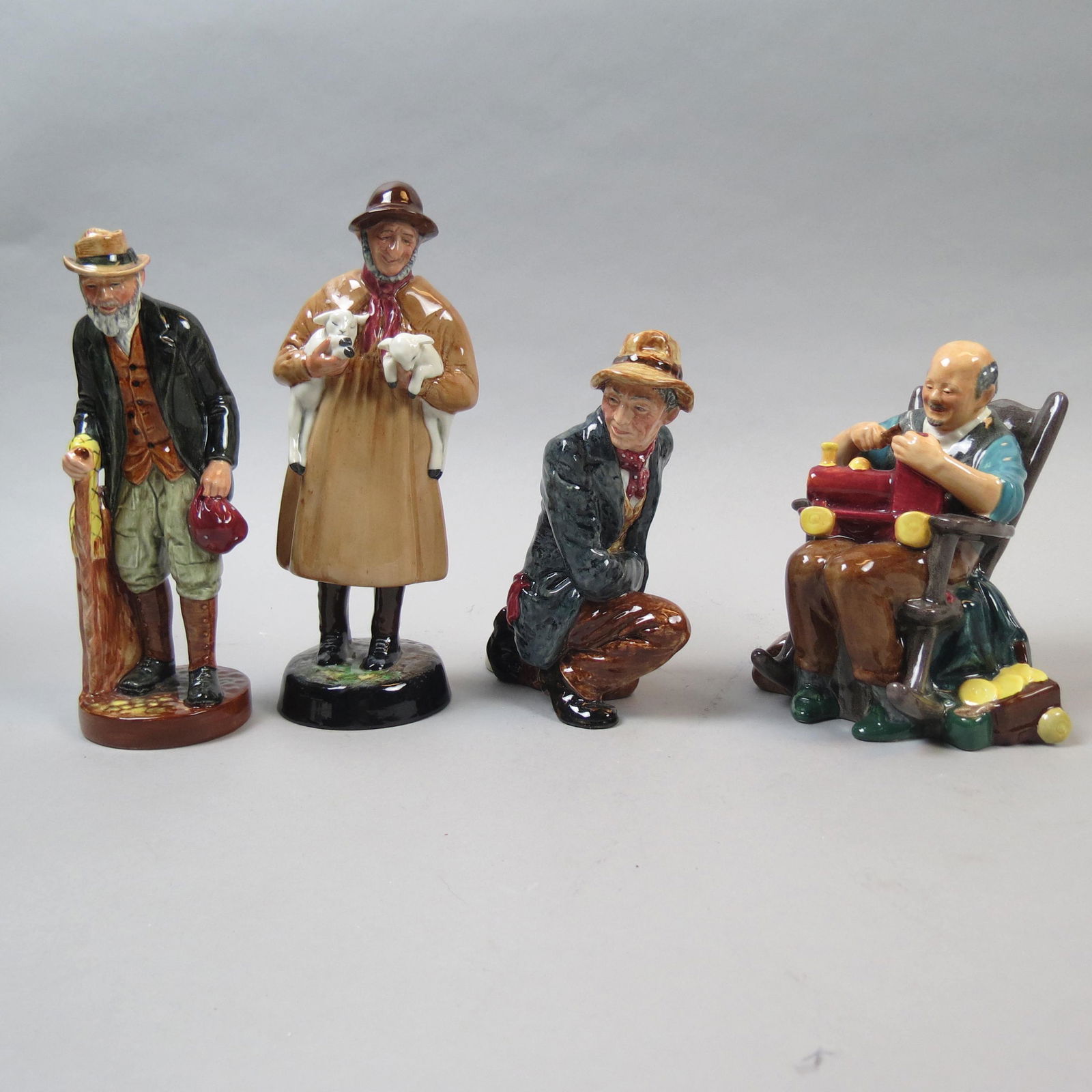 4 Royal Doulton Figurines: Lambing Time" HN1890, "The Poacher" HN2043, "The Gaffer" HN2053 and "The Toymaker" HN 2250, 6" to 8 1/2", all excellent.