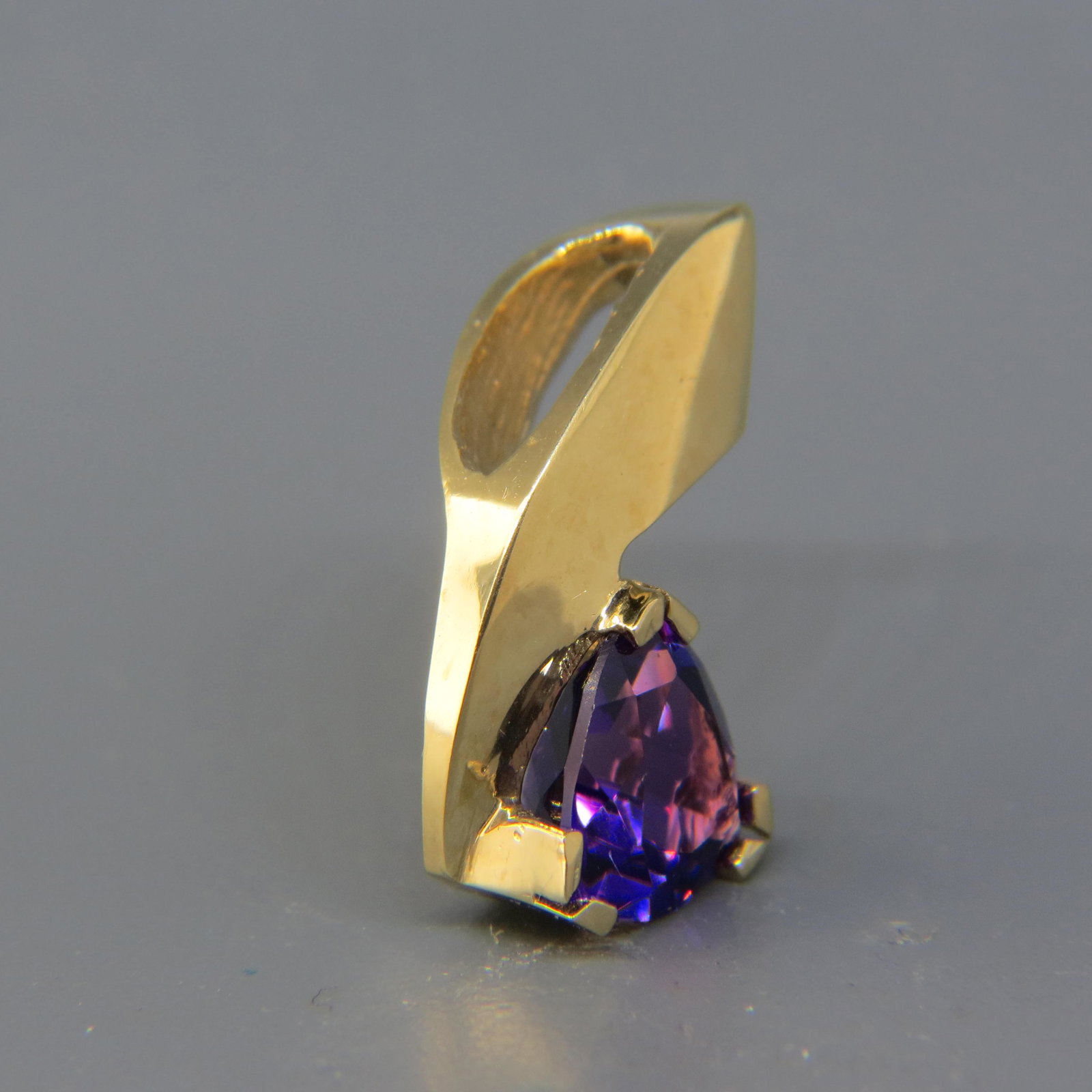 Amethyst 14K Gold Pendant: A rich triangular gem wieghing 2.75 carats in 14K yellow gold, with appraisal of $750.00, 1 long.