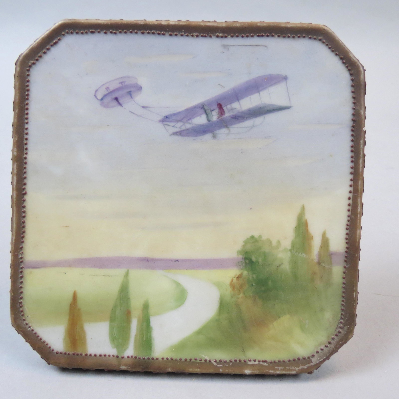 Nippon Porcelain Trivet with Aircraft in Flight: Hand painted, satin, 5 X 5", unusual scene.