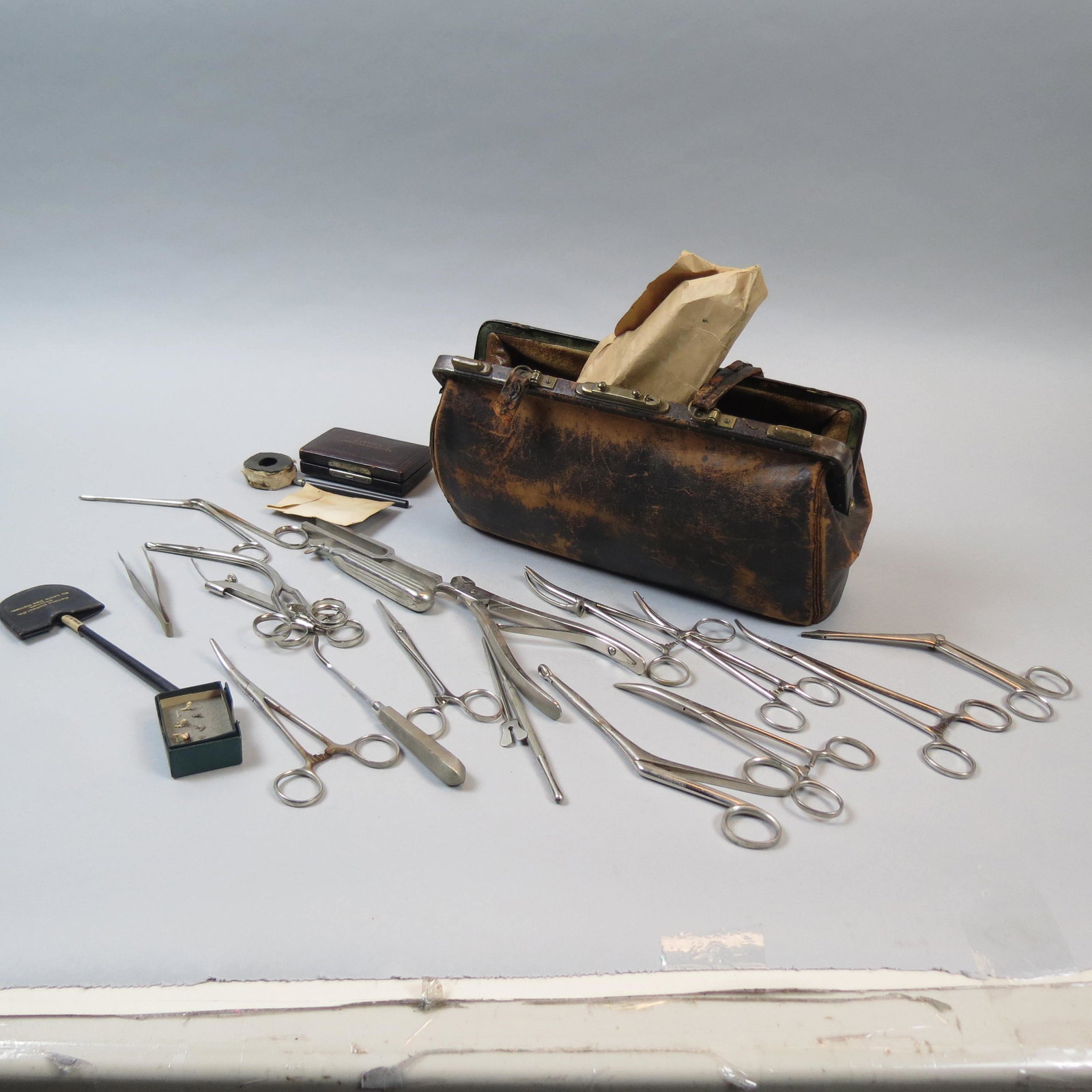 Antique Doctor's Bag with Implements: Leather and brass bag with contents, as found.