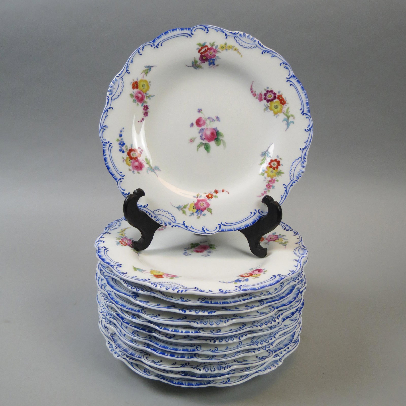 12 Fine Porcelain Hand Painted Plates: Floral sprays, blue borders, 9".