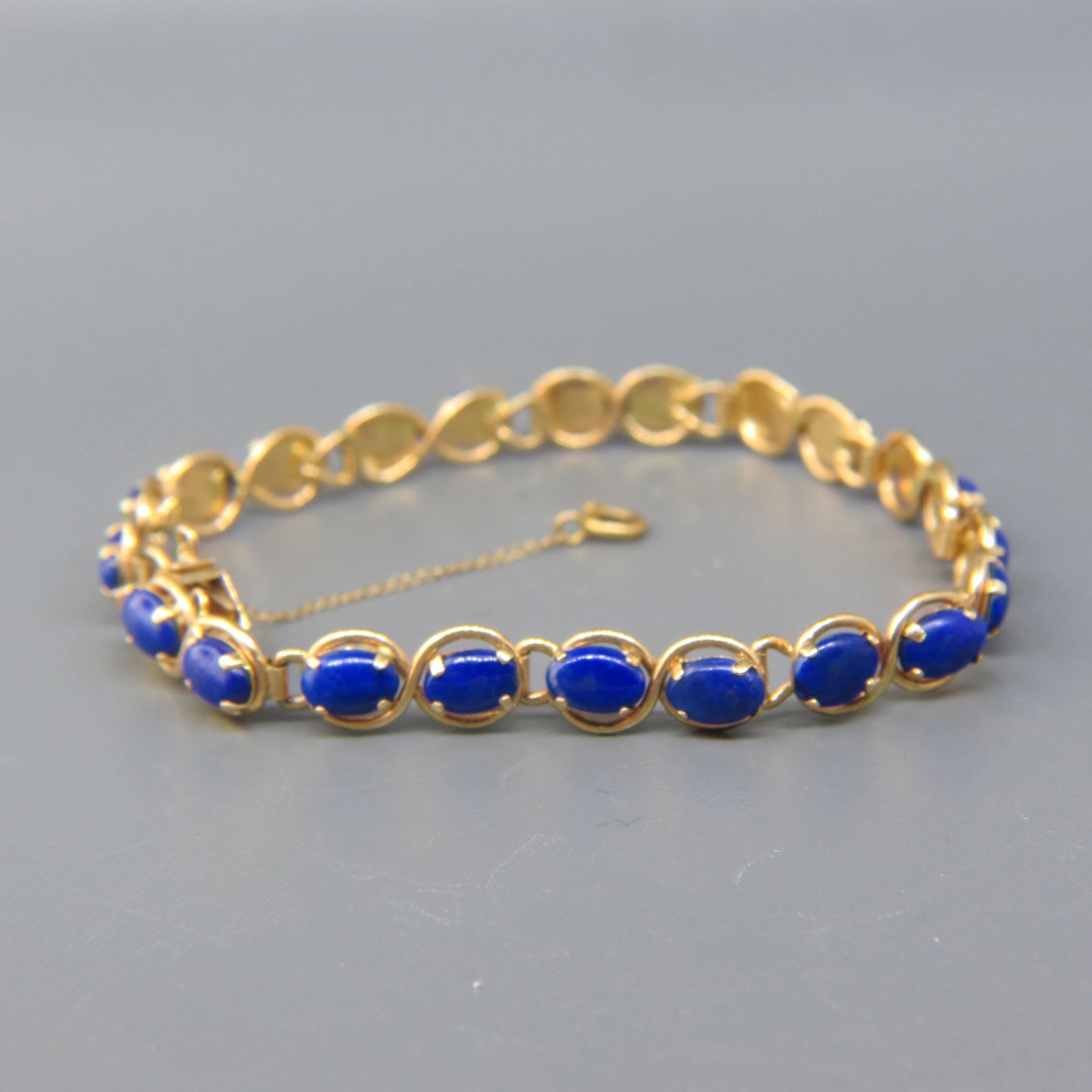 Lapis Lazuli 14K Gold Bracelet: 22 Rich cabochons in 14K gold, 6 3/4 long, 8.4 grams.