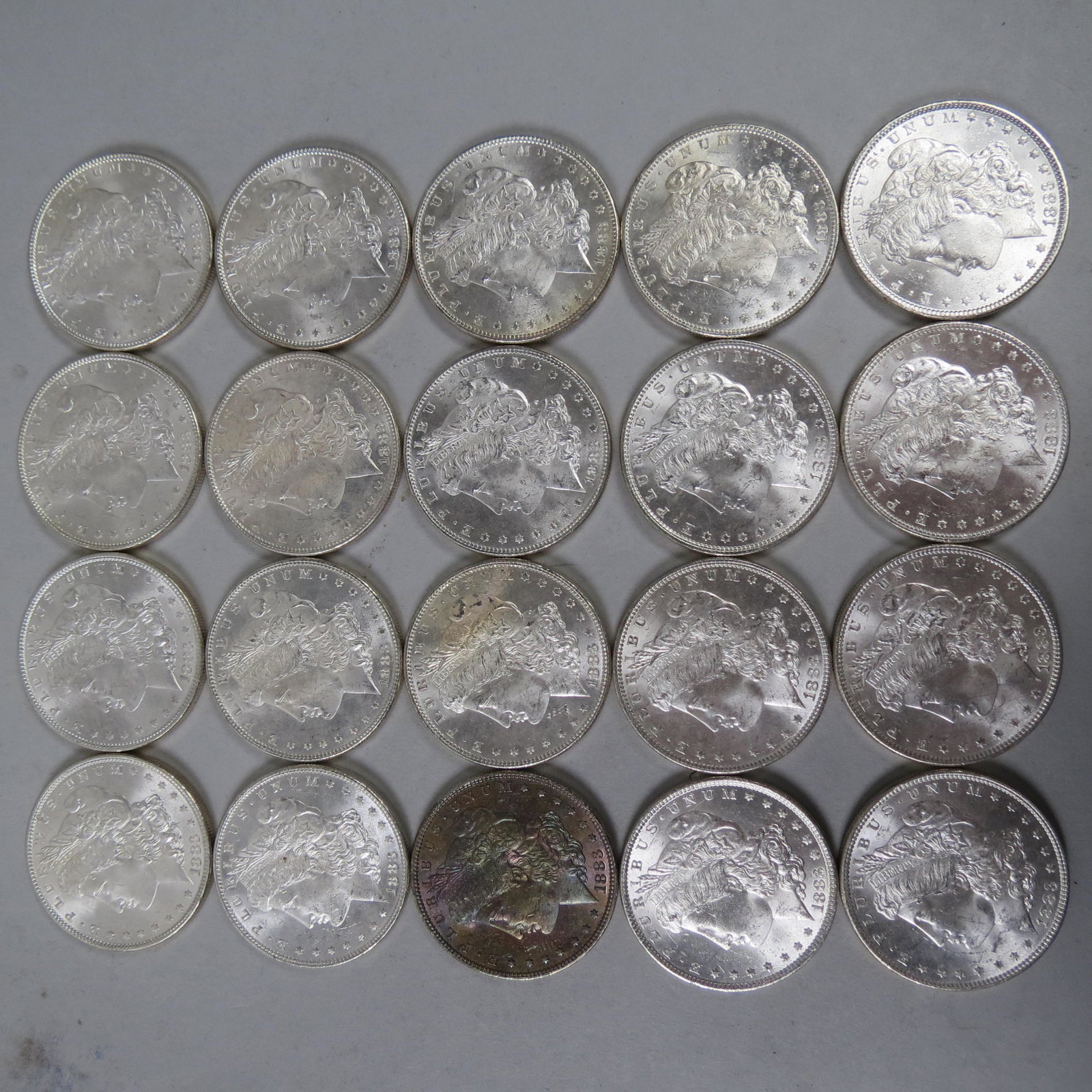 20-1883 Morgan Silver Dollars, uncirculated,: complete roll from a banker's estate.