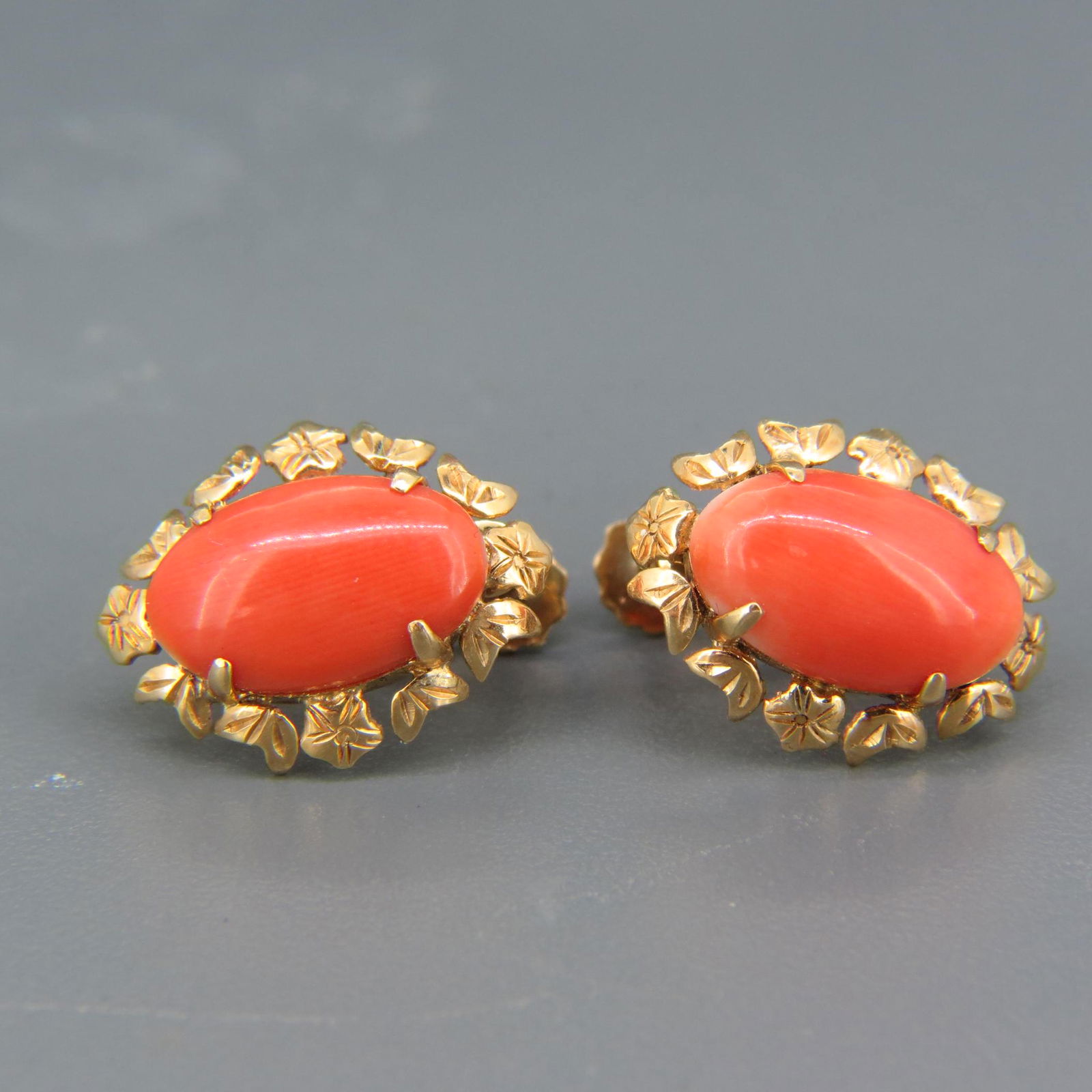 Coral & 14K Gold Earrings,: oval cabochons, floral designs around, 14K yellow gold, 1/2" X 3/4", screw back style.
