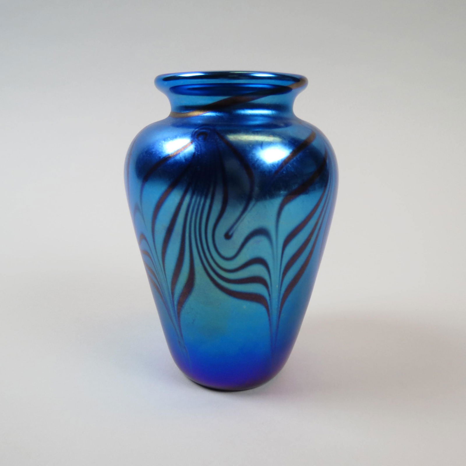 Orient & Flume Art Glass Vase,: pulled feather on iridescent blue, 6" tall, signed and dated 1991, excellent....Orient & Flume produces fine art glass for the collector. These signed pieces capture nature's inspiration in both iride