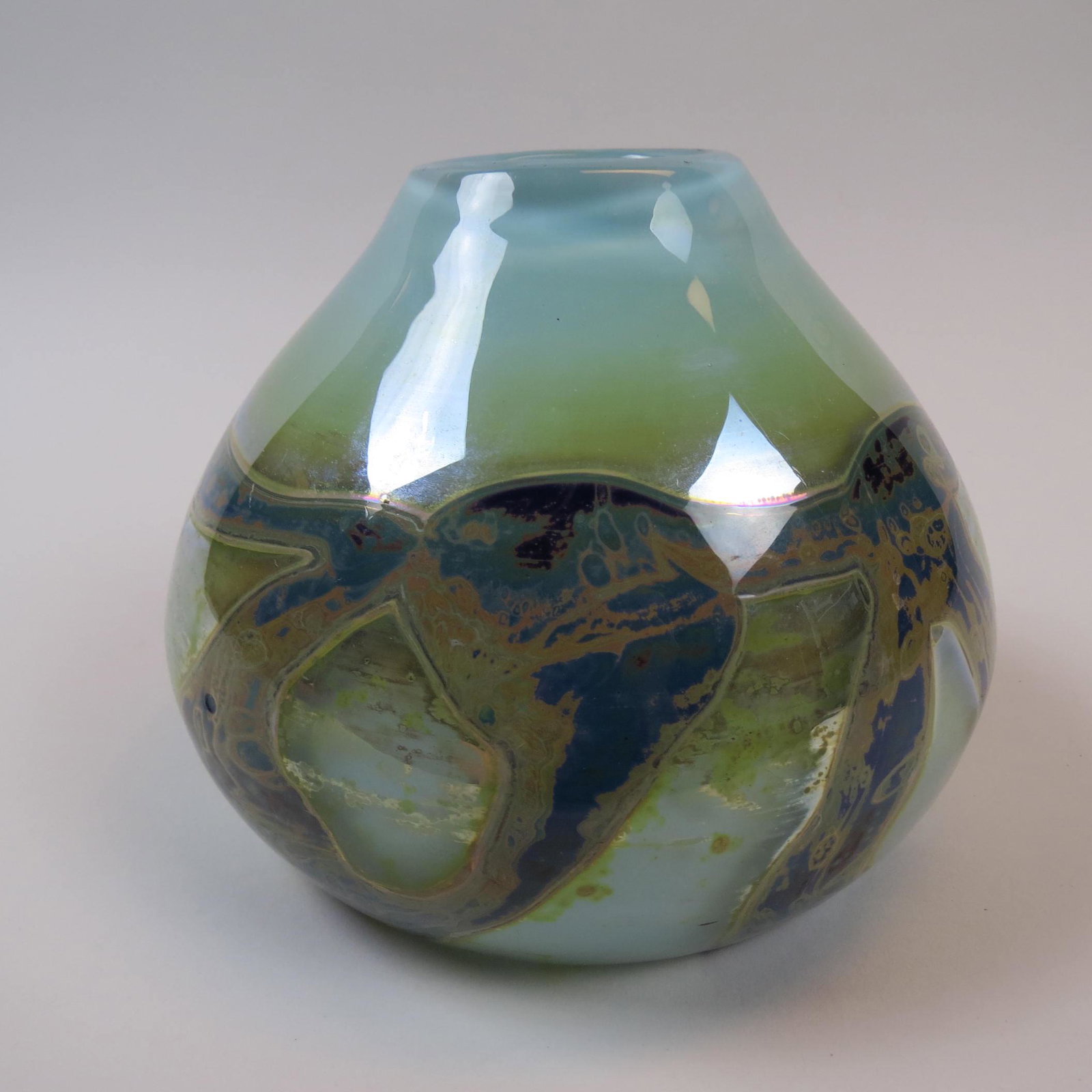 Nicholas Nourot Studio Art Glass Vase,: blue, yellow and brown trailing on opalescent white interior, signed and numbered, 6" tall, 8" diameter, excellent....Nourot Art Glass Studio was founded in 1974 by husband and wife Micheal Nourot and