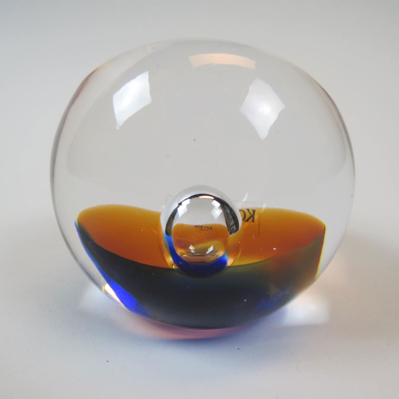 Kosta Boda Art Glass Paperweight,: by artist Goran Warff, internal blue and yellow with bubble decoration, oval shape cut top, signed and numbered, 3" X 3 1/2", excellent.
