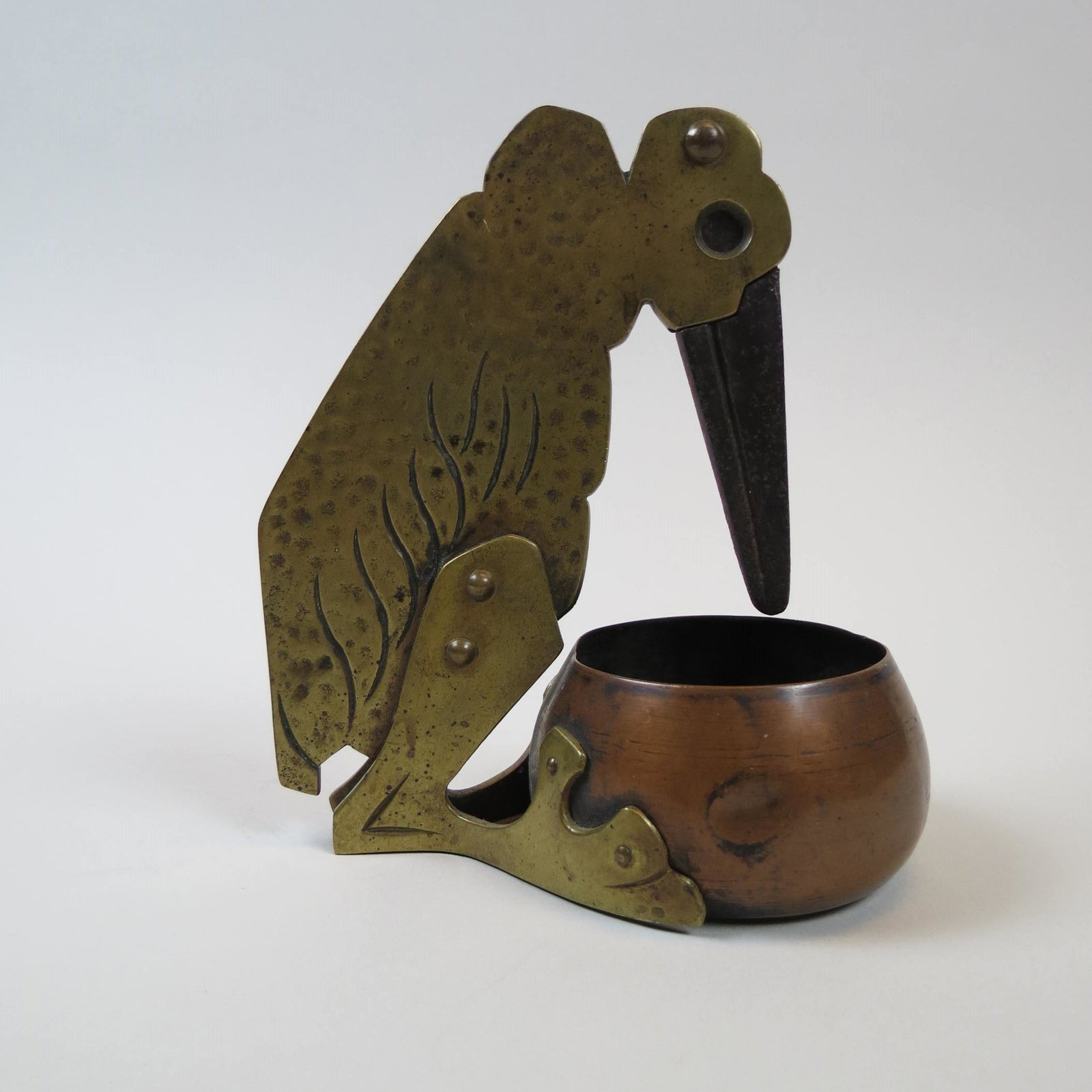Figural Bird Cigar Cutter Arts & Crafts Era,: brass bird with long beak, copper bowl at his feet, 5 3/4" tall.