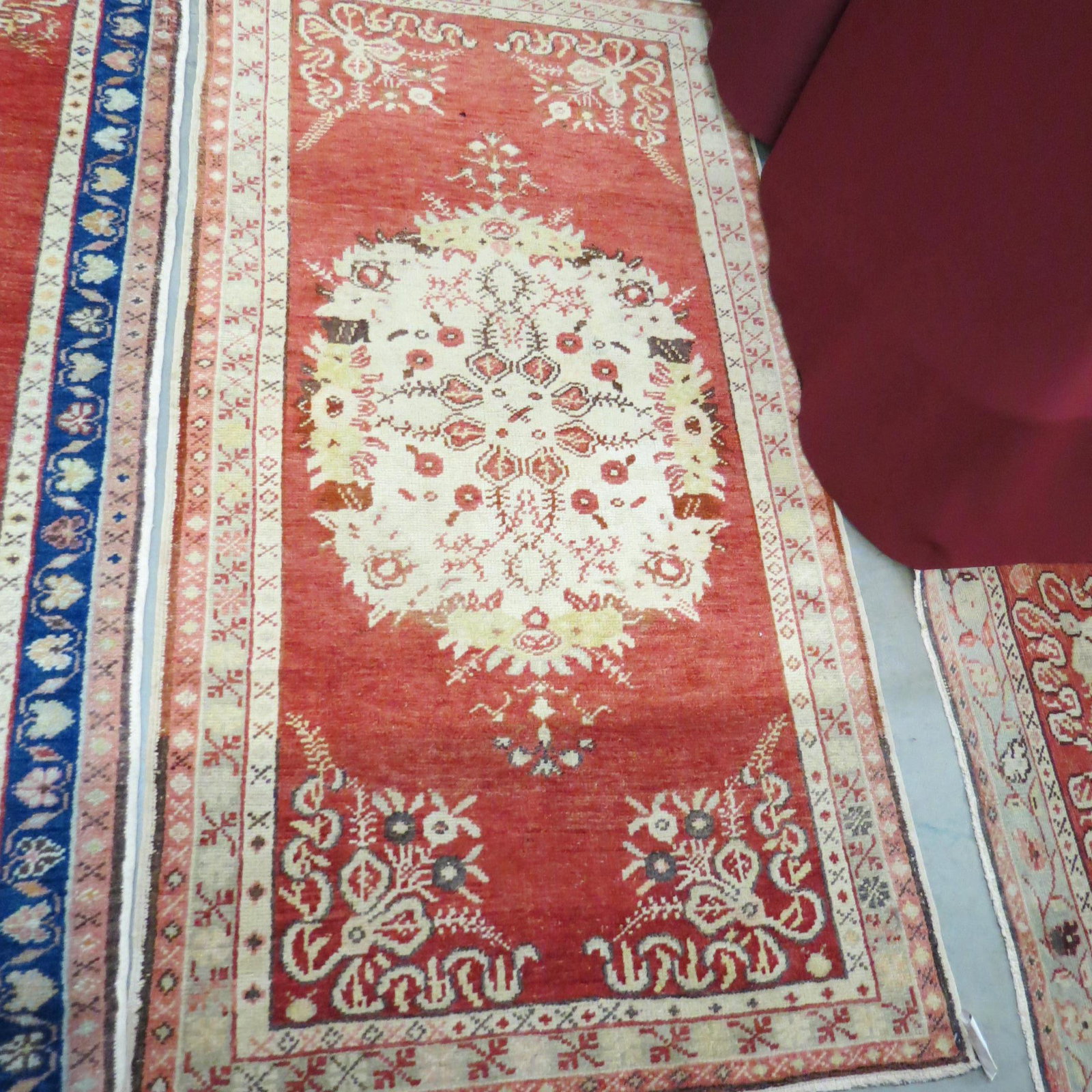 Oushak Turkish Handmade Rug,: floral center on ivory with salmon field, flowers and bow designs in corners, 3'1" X 6'.