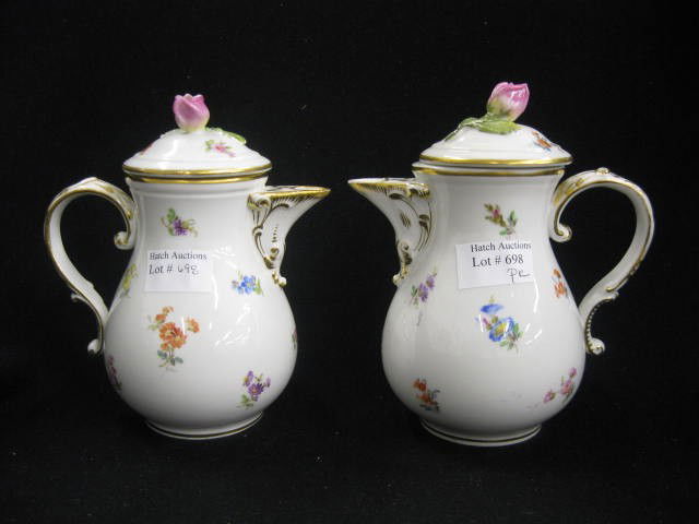 Pair of Meissen Porcelain Cream Jugs, handpainted: handpainted floral sprays, rose finials, crossed swords mark, 6" tall, one has minor rim chip.