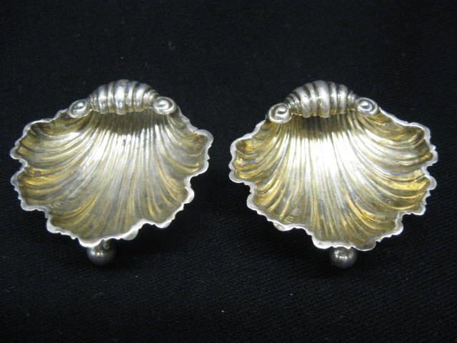 Pair of Sterling Silver Figural Salt Cellars, she: shell form, gold wash interior, ball feet, 2", unmarked.