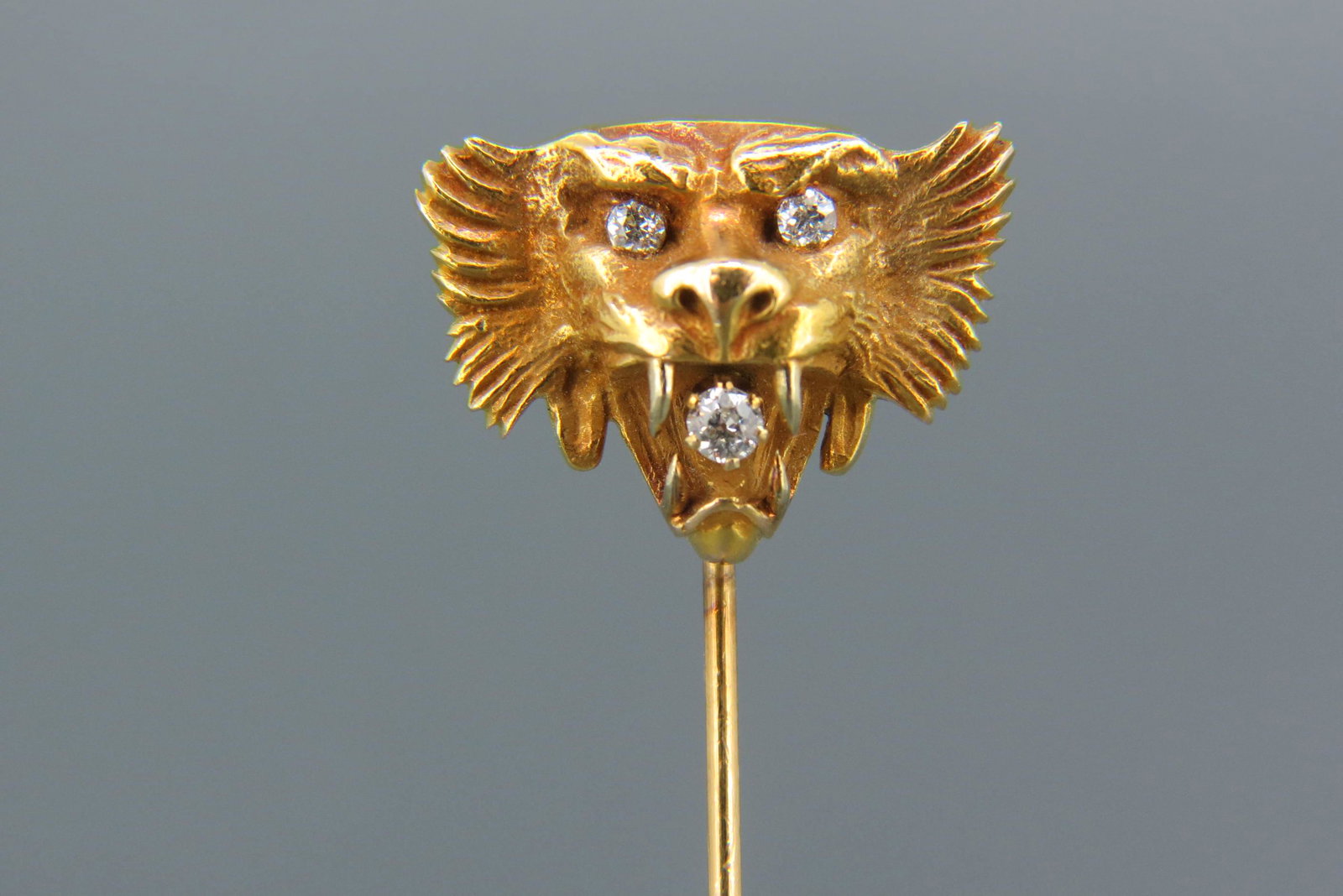 Diamond & 14K Gold Lion's Head Stickpin,: 3 round diamonds in 14K yellow gold, dated 1902, 2 1/2" long, 4 grams.