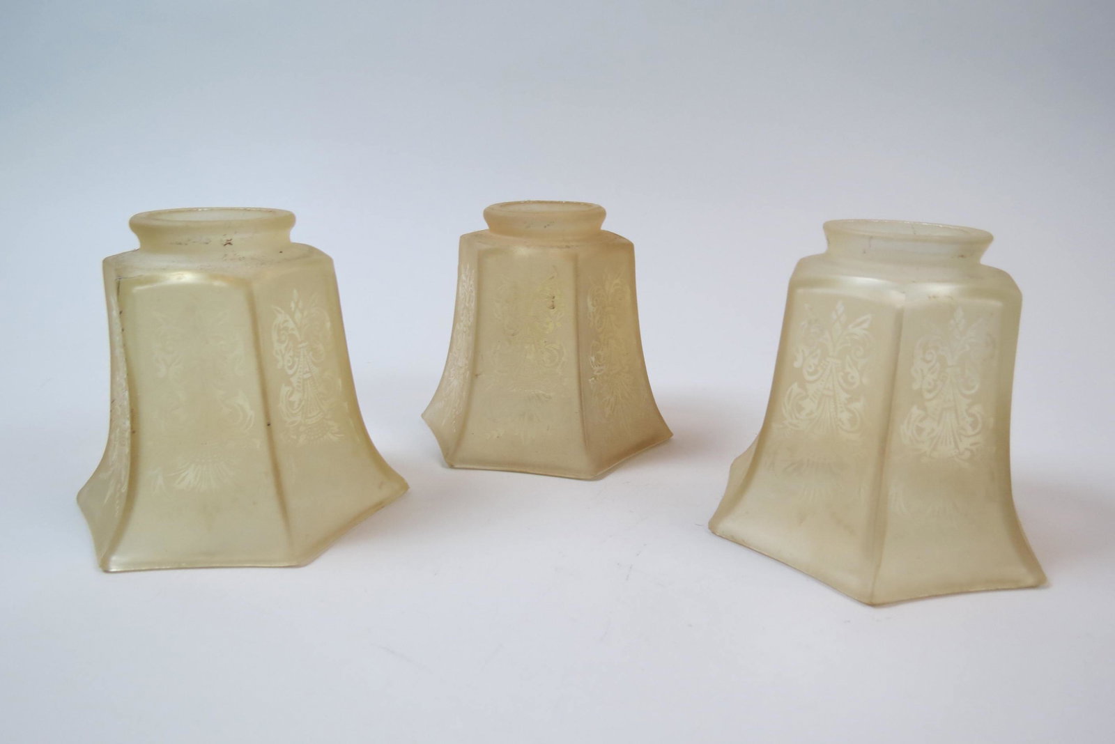 3 Art Glass Shades,: acid etched Art Deco style design on frosted light amber, hexagon body, 4 1/2" with 2 1/4" fitters.