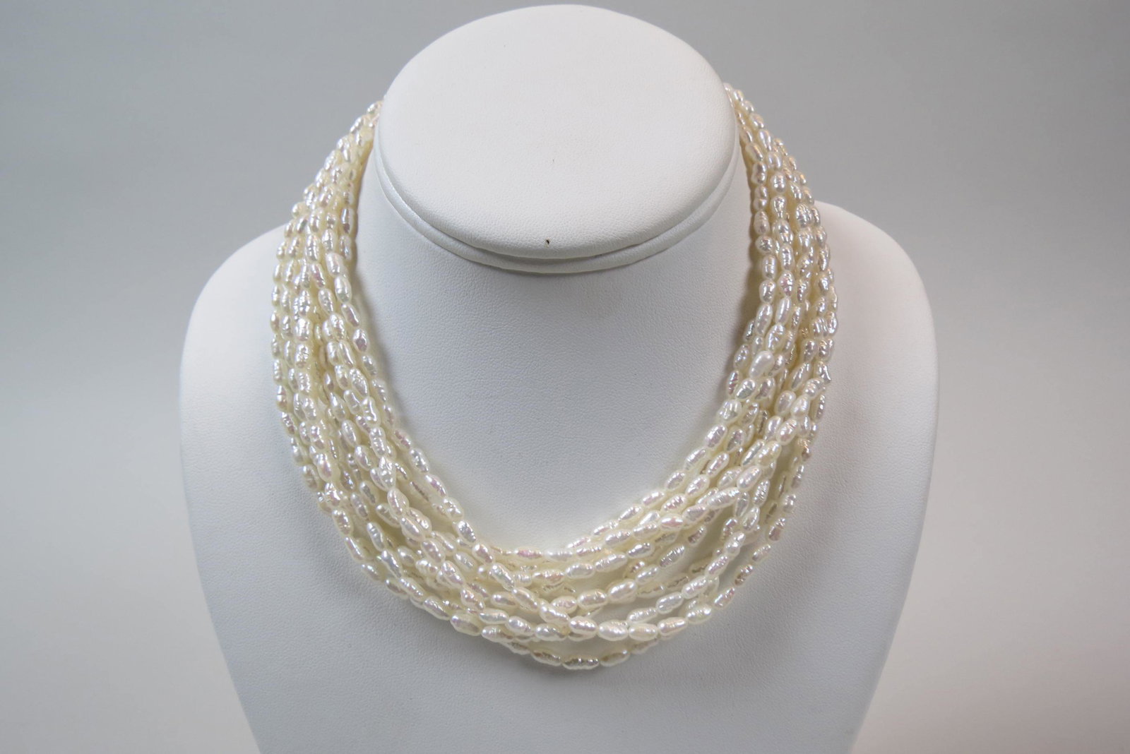 Diamond & Pearl Necklace, 30 round diamonds: in bow shaped 14K white and yellow gold clasp, 9 strands of freshwater "rice" pearls, 16 1/2" long.