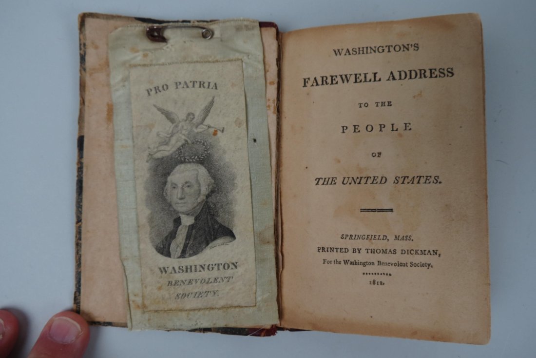 1812 Washington Farewell Address Book & Ribbon: for the Washington Benevolent Society, for member Eli Burt, the 1812 book printed by Thomas Dickman and is signed by the society president John Hooker and secretary Edmund Blife, 3 1/2" X 4 1/4" book,