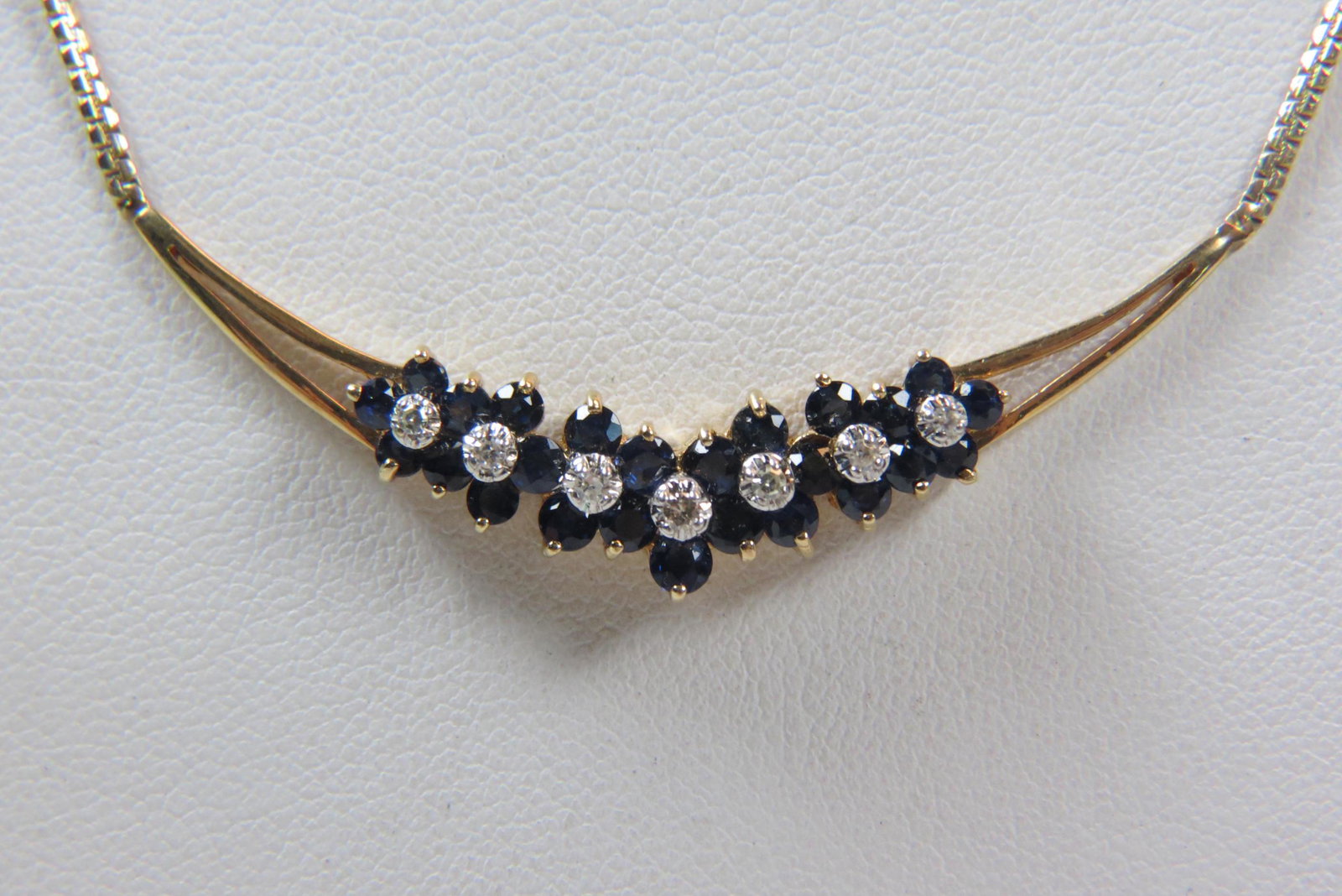 Sapphire & Diamond 14K Gold Necklace,: 25 round rich blue gems totaling 1 carat and 7 round diamonds totaling .12 carat in 14K yellow gold, with appraisal of $1,750.00, 16" long.
