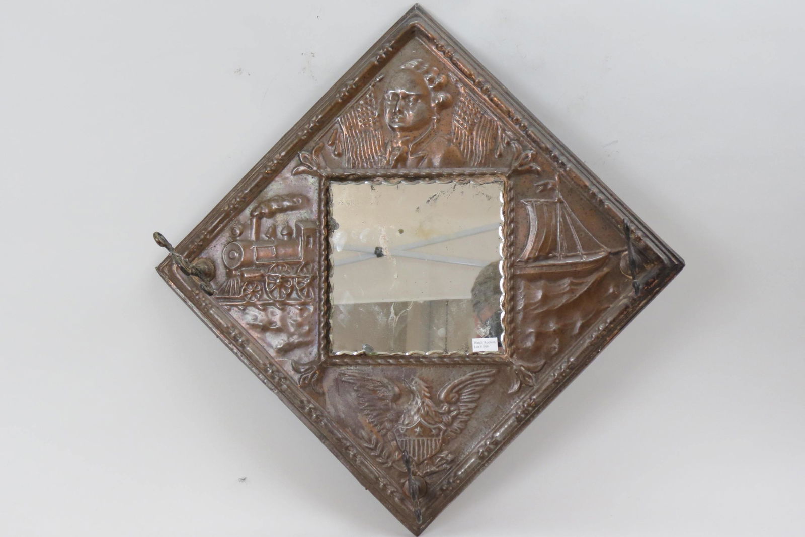 1909 Hudson Fulton Celebration Wall Hat Rack,: with mirror and brackets, raised copper designs including locomotive on left, ship on right, bust of Robert Fulton at top and eagle below, 18" X 18".