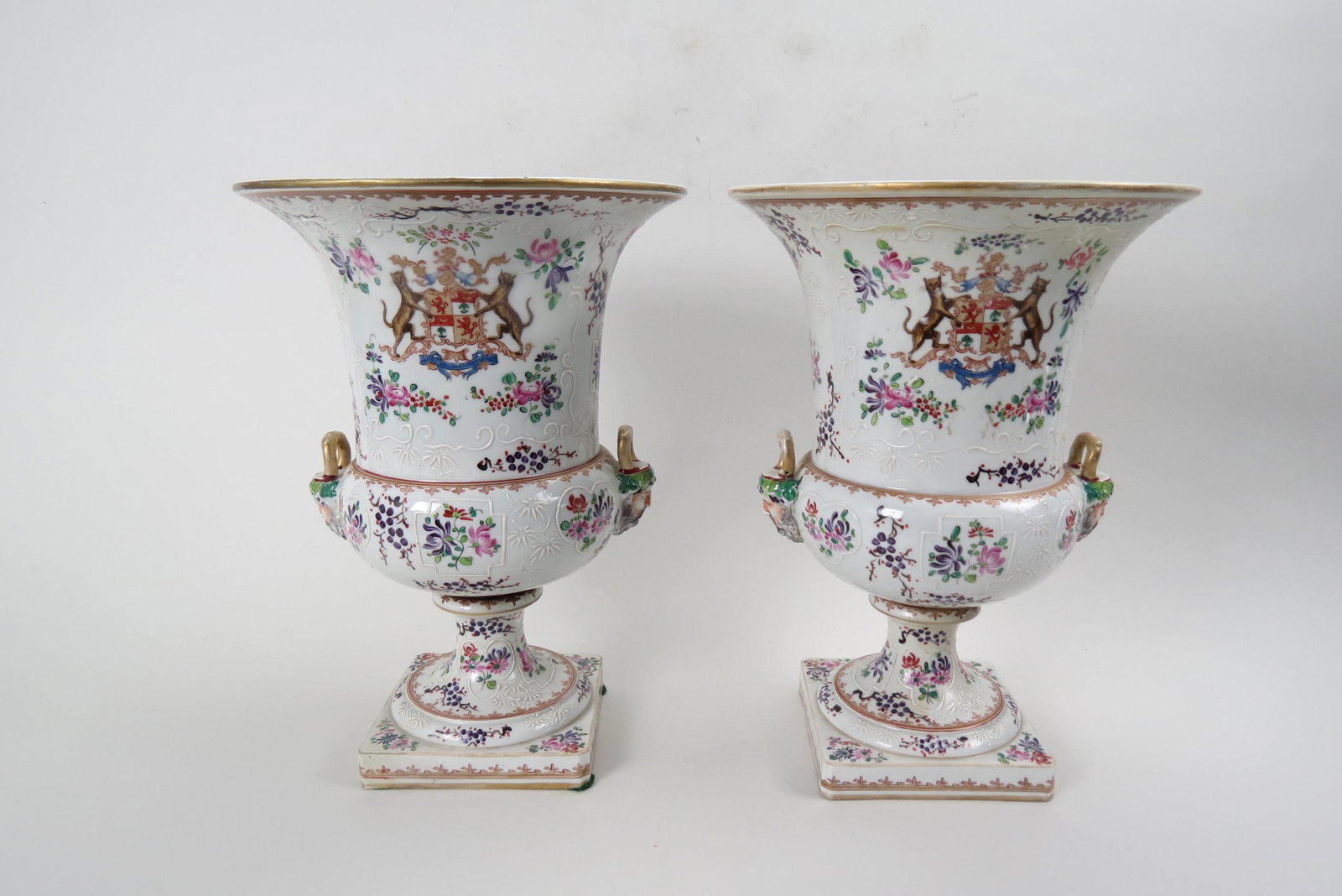 Pair of Samson Armorial Porcelain Urns or Wine: Coolers, face of Bacchus on handles, hand painted flowers, raised slip decoration, pedestal bases, signed, 13 1/2" tall, one restored.