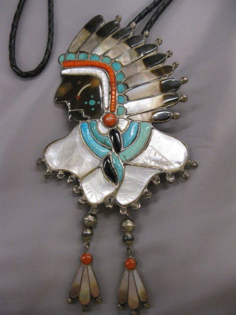 Indian Bolo Tie, figural chief design with turquo: figural chief design with turquoise, abalone, coral, black onyx & tortoise shell inlay, in sterling, signed, 3" x 6", excellent.