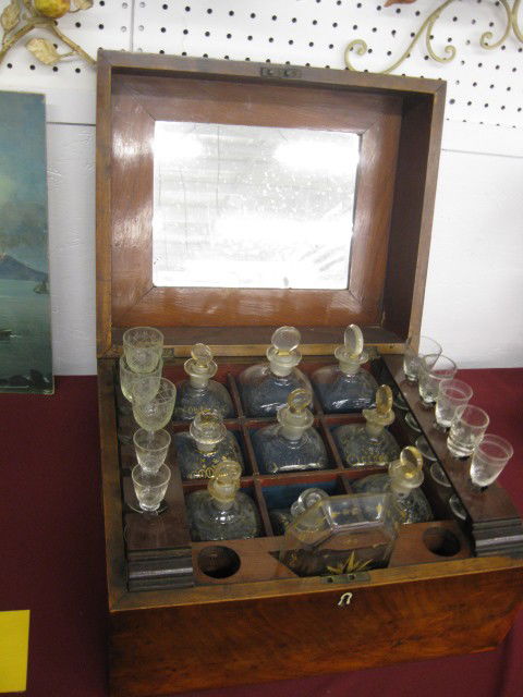 19th Century Travel Bar or Tantalus, 9 bottle, mah: 9 bottle, mahogany case, bottles have gold decoration, original, glasses are replaced, circa 1850.