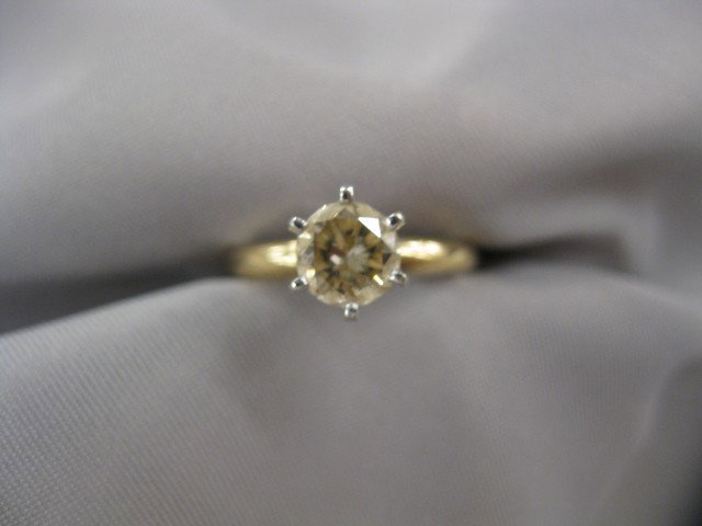 Diamond Solitaire, .85 carat fancy champagne color: .85 carat fancy champagne color round brilliant in 14k yellow gold.